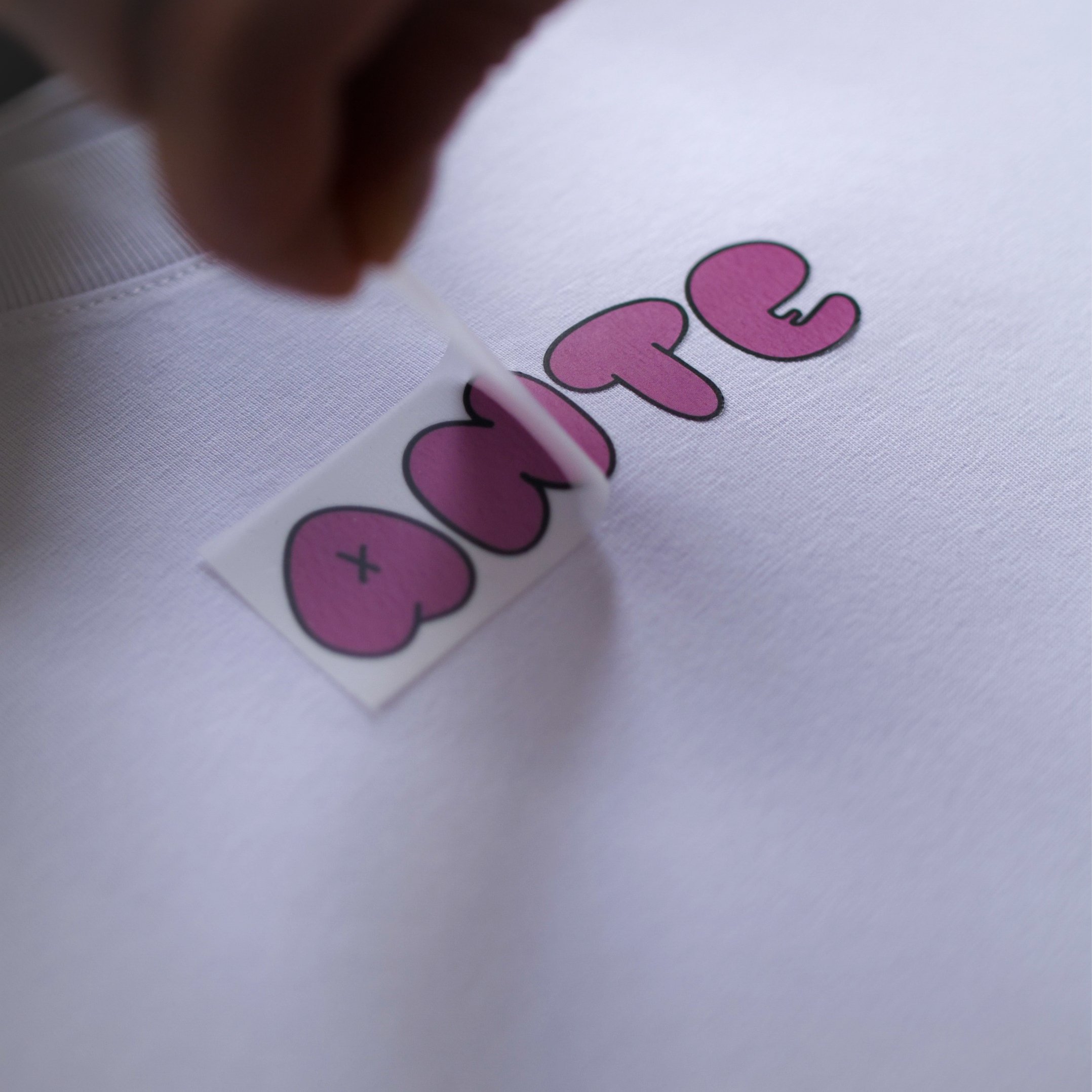 Behind-the-scenes merchandise production showcasing custom apparel printing and creative craftsmanship.