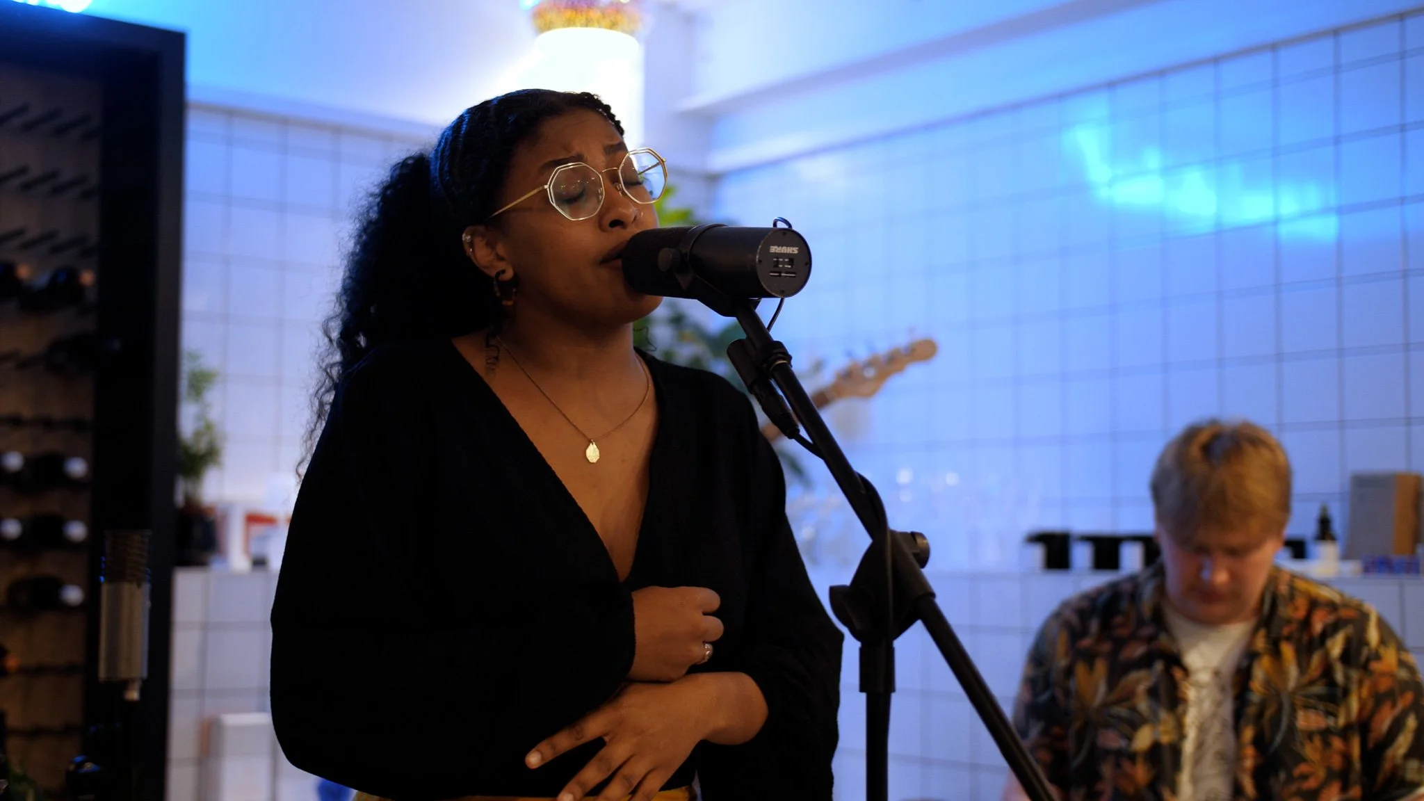 Live music performance photography capturing a singer during an intimate acoustic session.