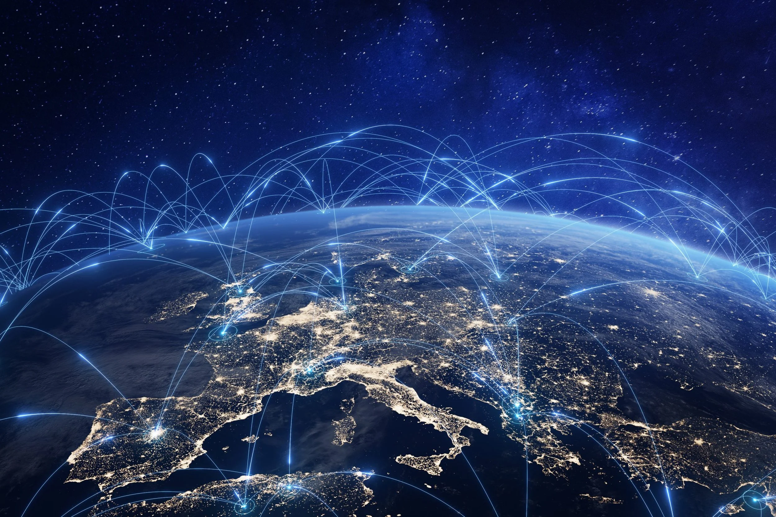A view of Europe from space at night with illuminated cities and digital network lines connecting different locations across the continent and beyond.