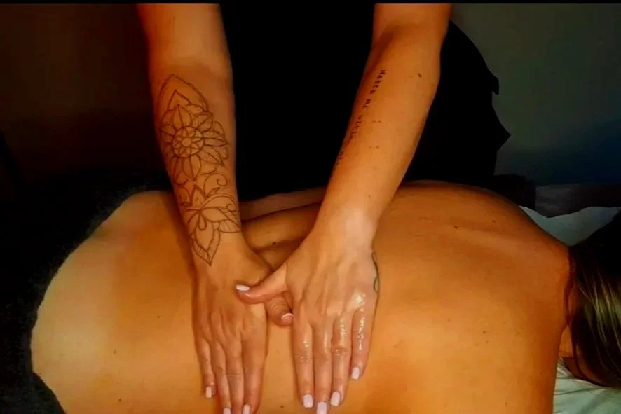 Person receiving a back massage from a massage therapist.