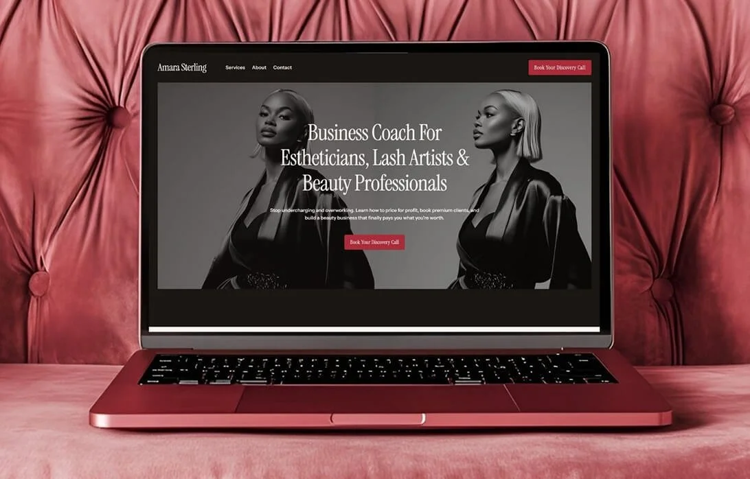 A pink velvet couch with a laptop open on the cushion showing a website for a business coach for estheticians, lash artists, and beauty professionals.