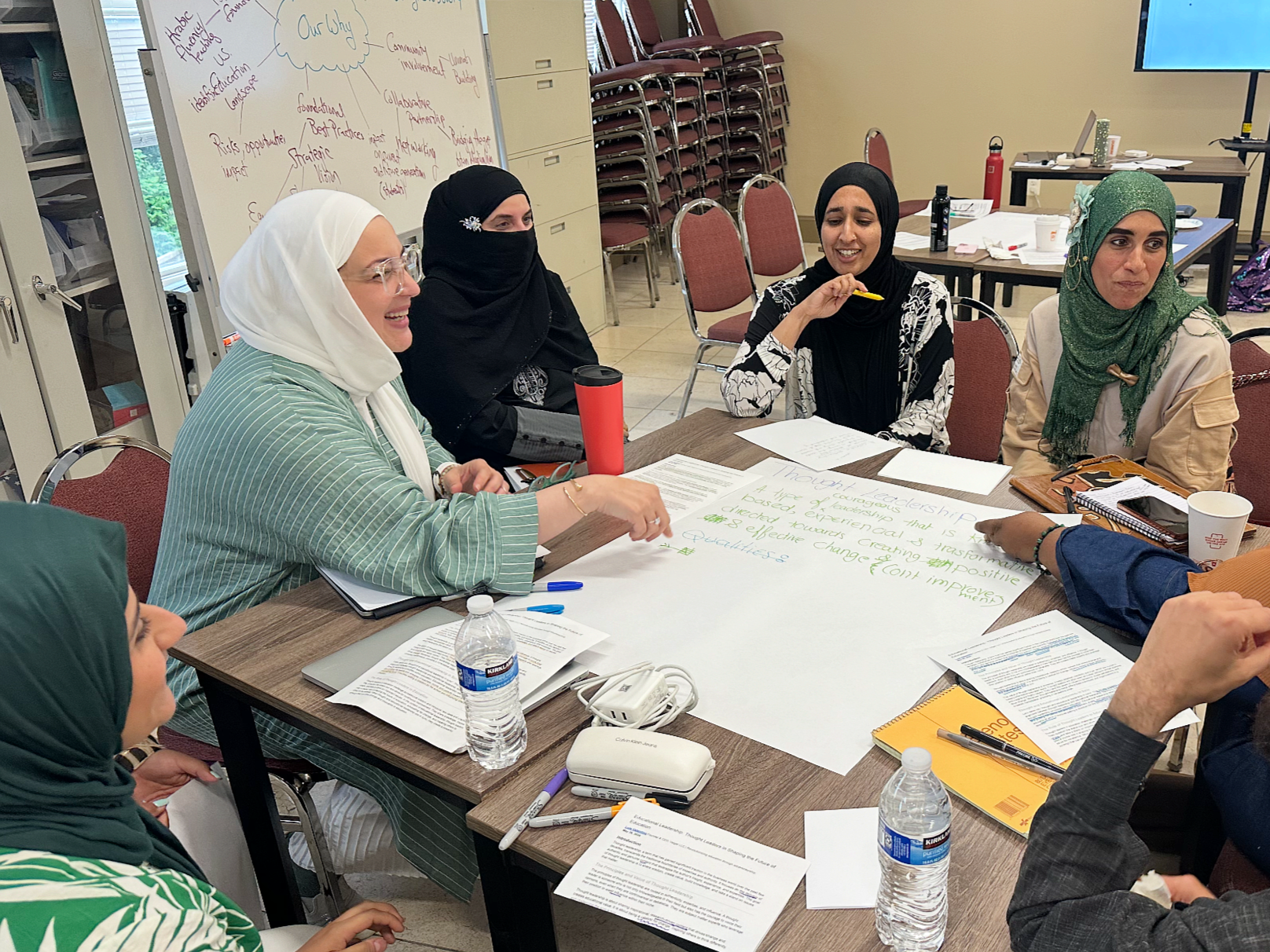 an image of muslim educators in our monthly meetings discussing thought leadership