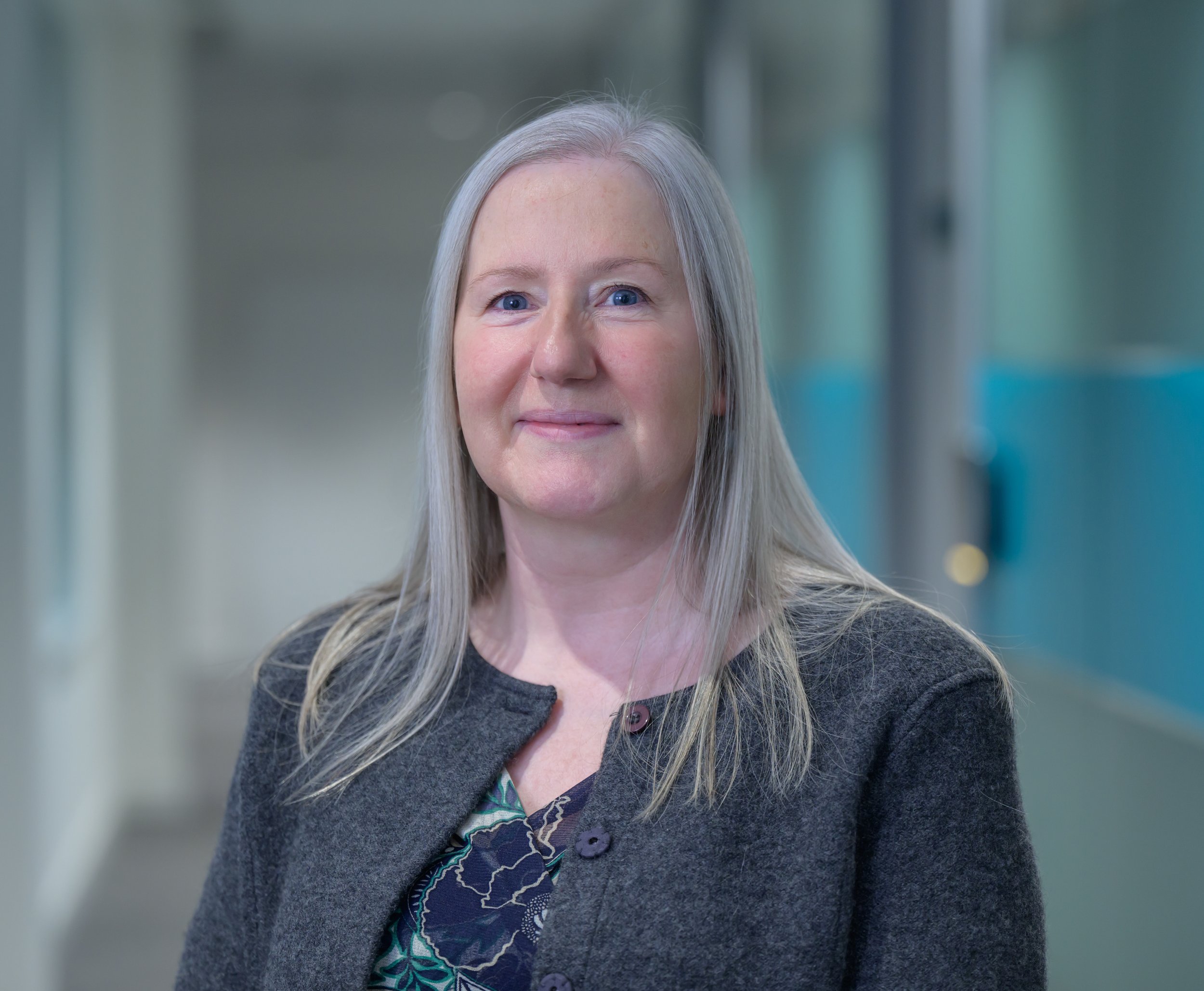 A photo of Gillian Murray of Slipperfield Building Consultancy. She has grey hair and blue eyes and is smiling