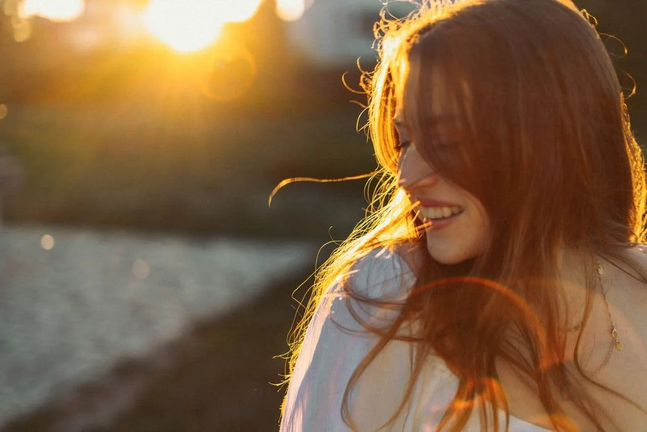 a-portrait-of-a-happy-woman-at-sunset