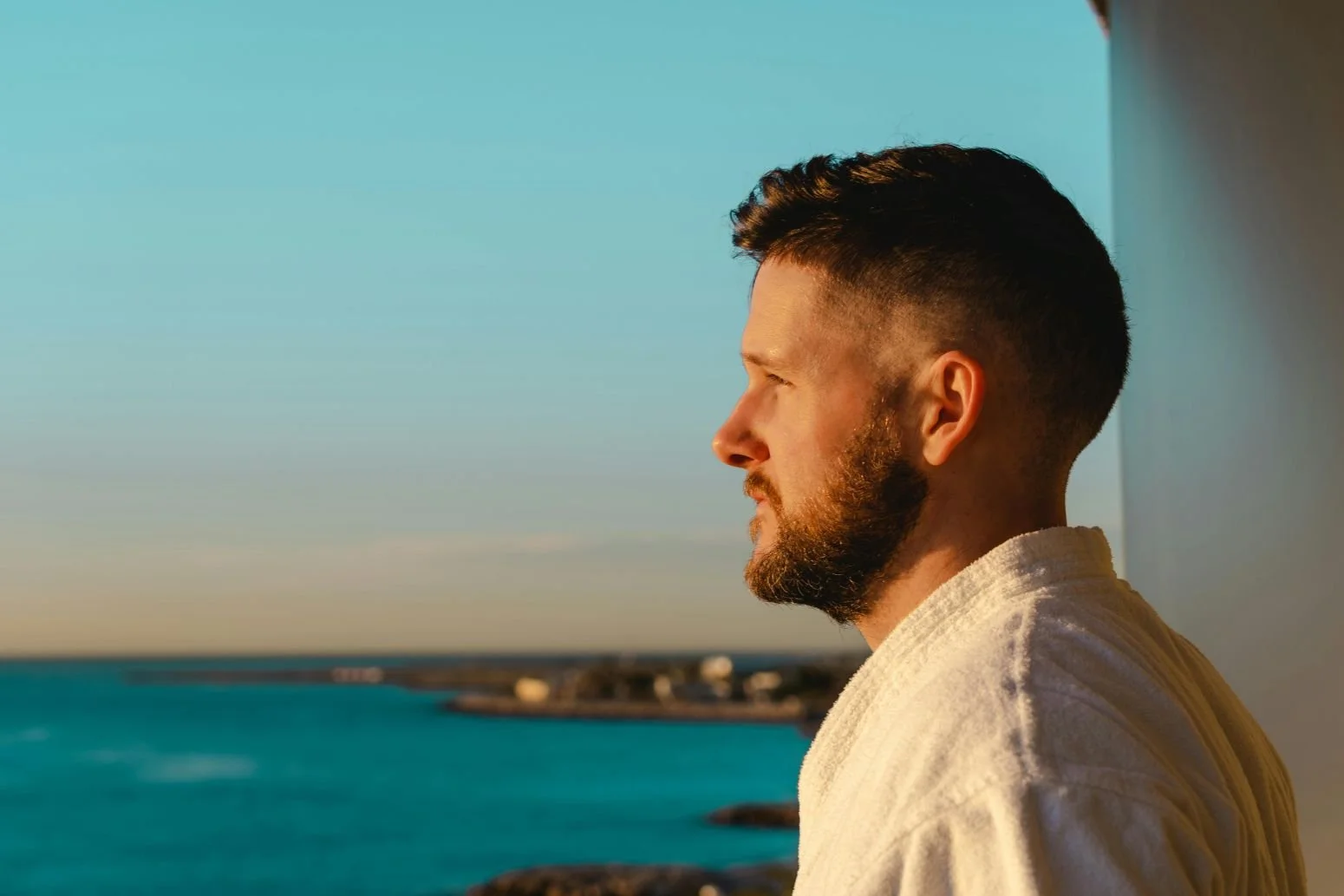 man looking over balcony