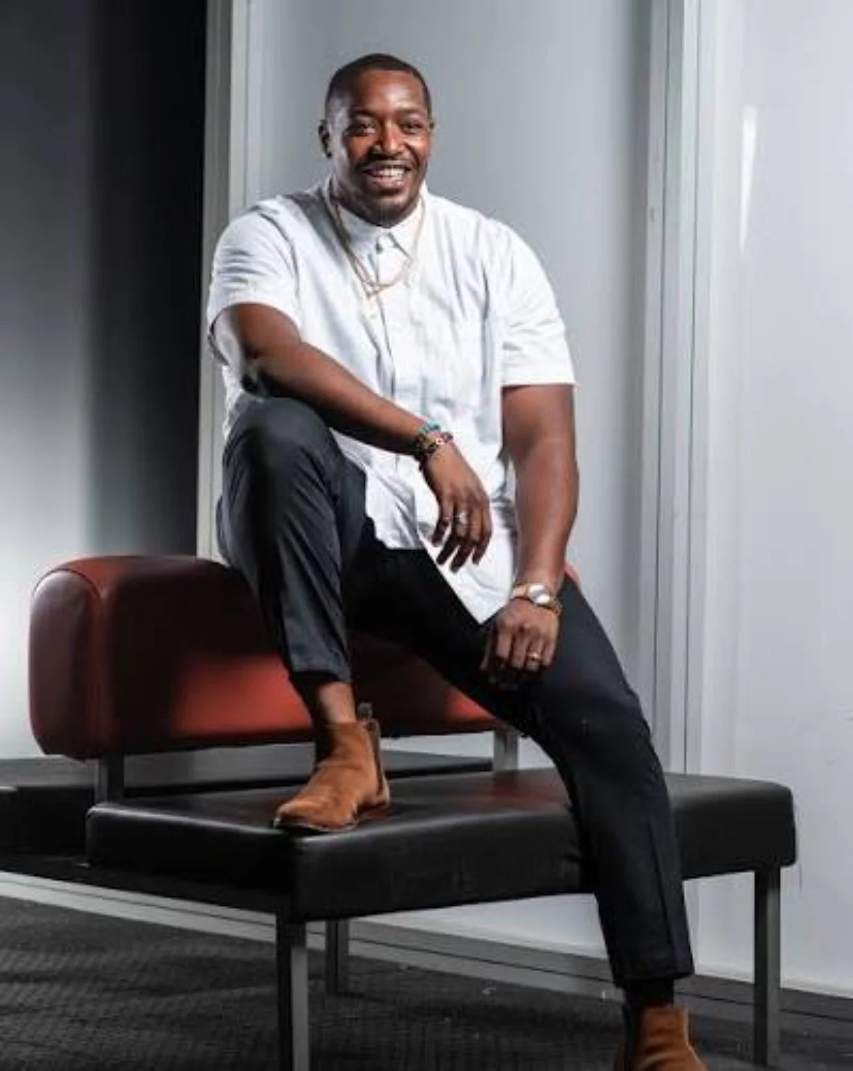 Dorelle Brock, Experience Design & Implementation at Rhize, smiling while seated on a bench.