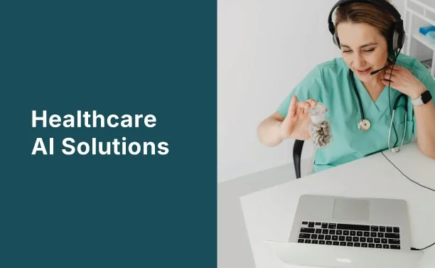 A healthcare professional wearing a headset, sitting at a desk with a laptop, holding a stack of coins, smiling.