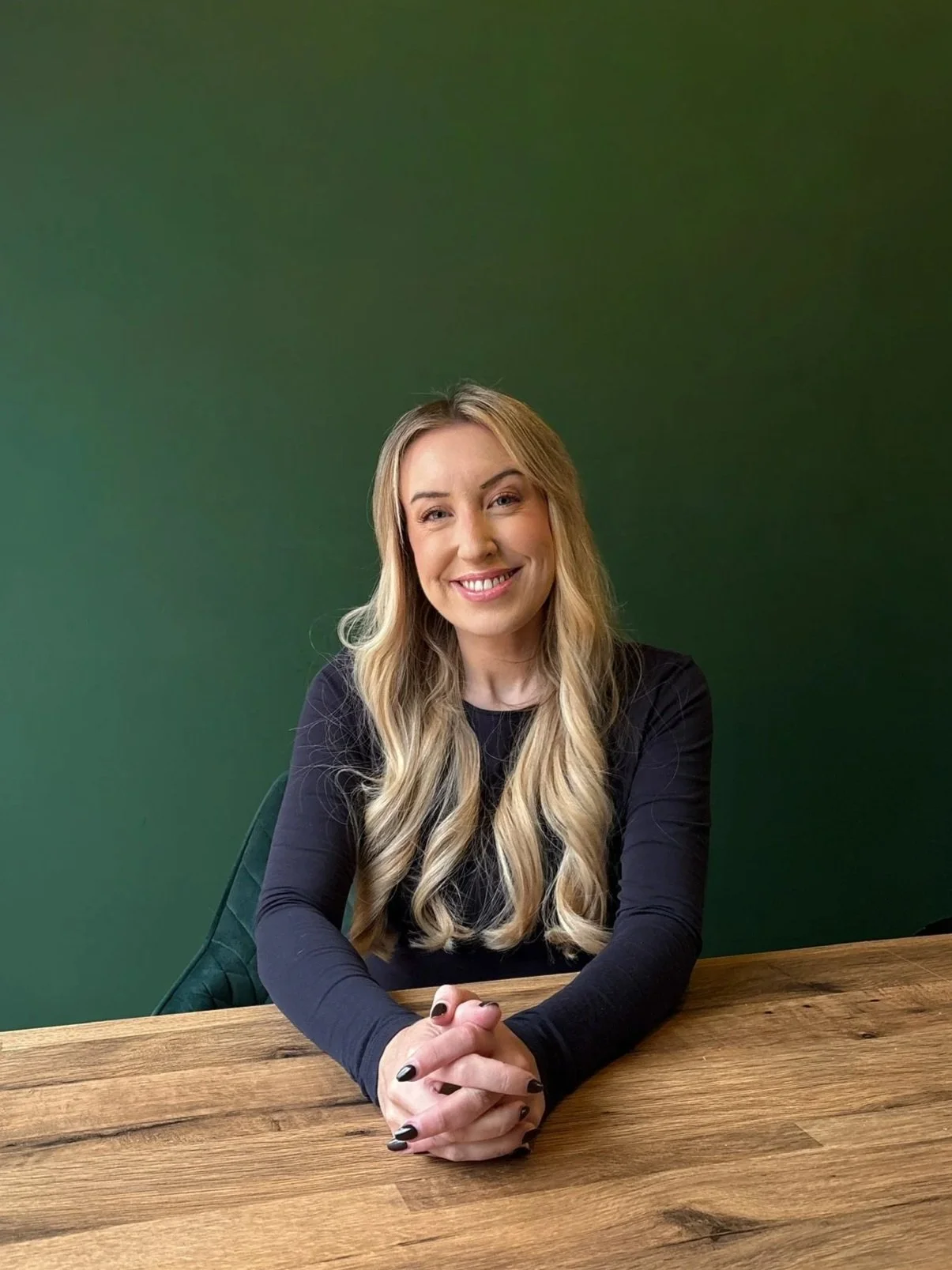 Claire Bree, a trauma therapist working with PTSD and complex trauma, smiling softly against a neutral background.