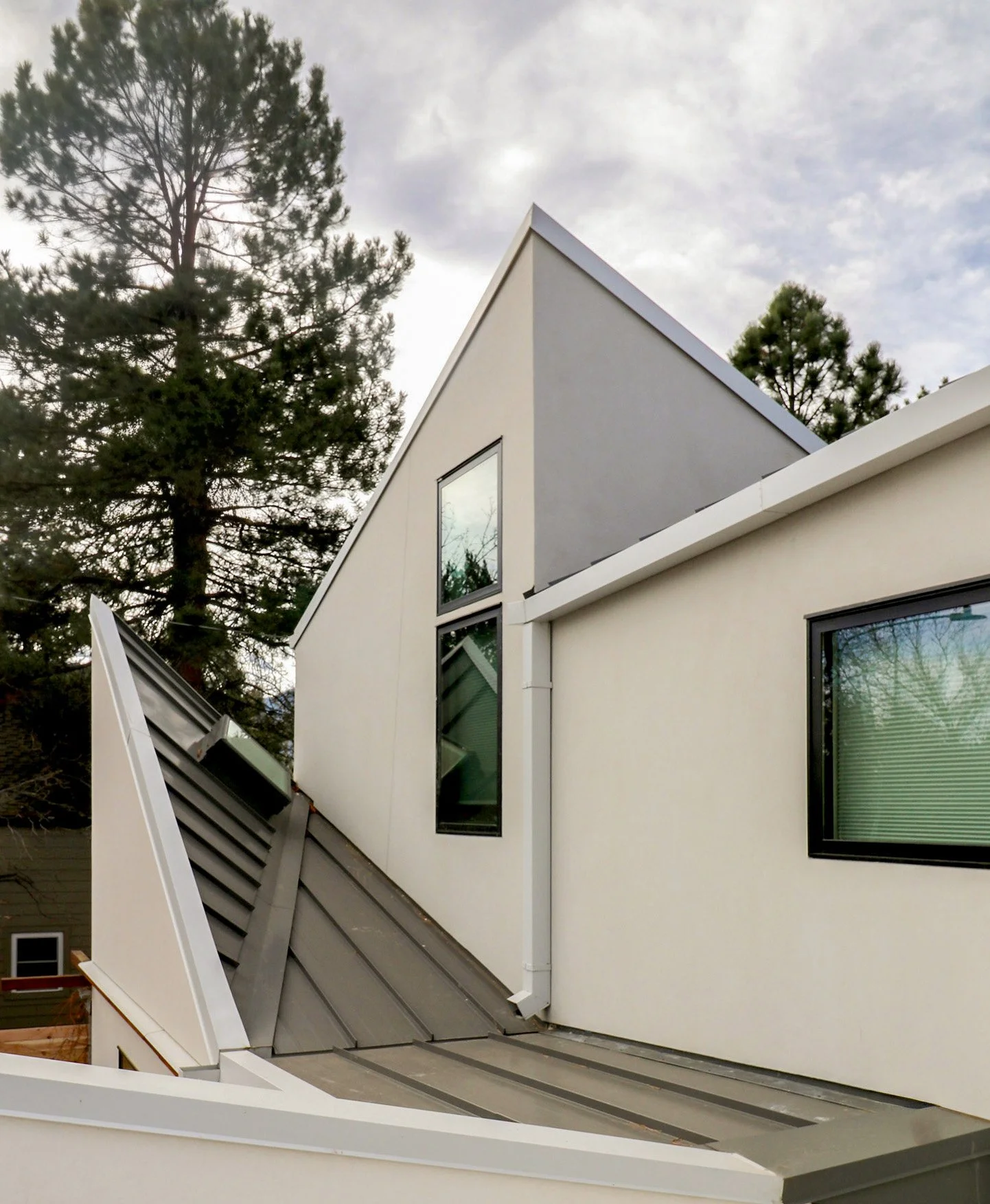 Mountain-inspired roofscape of the Tectonic House showing sculptural roof planes that lift and shift to bring natural light deep into this custom home in Boulder, Colorado.