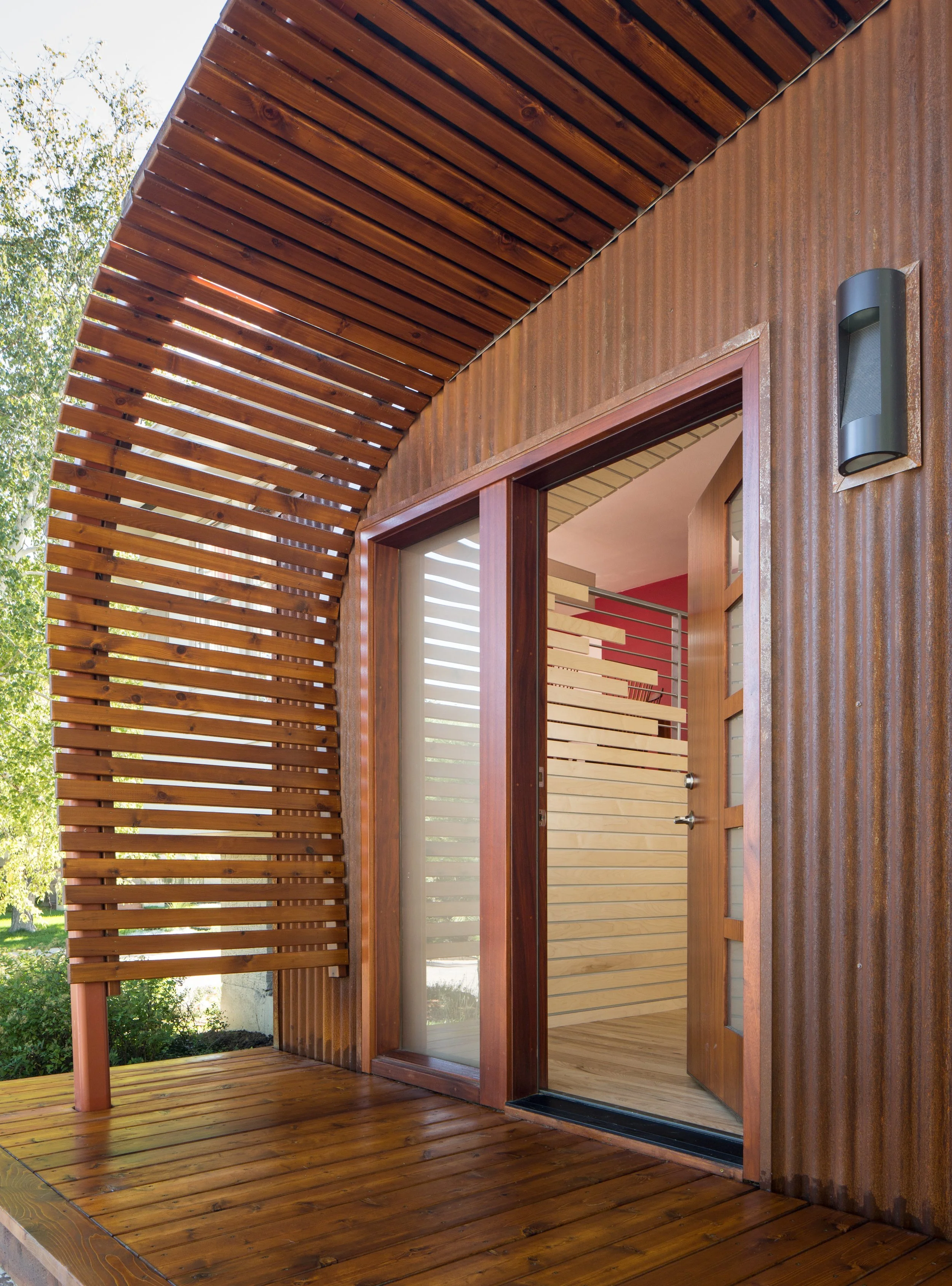 Ecotone House entry by AsOne Architecture with sculptural cedar screening inspired by the transition between forest and meadow in a modern Colorado home.