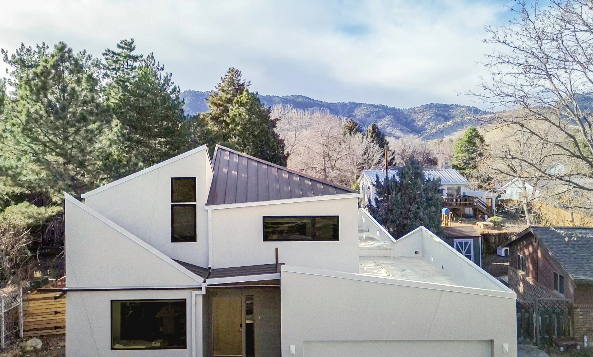 Aerial view of the Tectonic House by AsOne Architecture, a modern Boulder custom home whose folded roofscape echoes tectonic mountain formations and frames views of the Colorado Front Range.