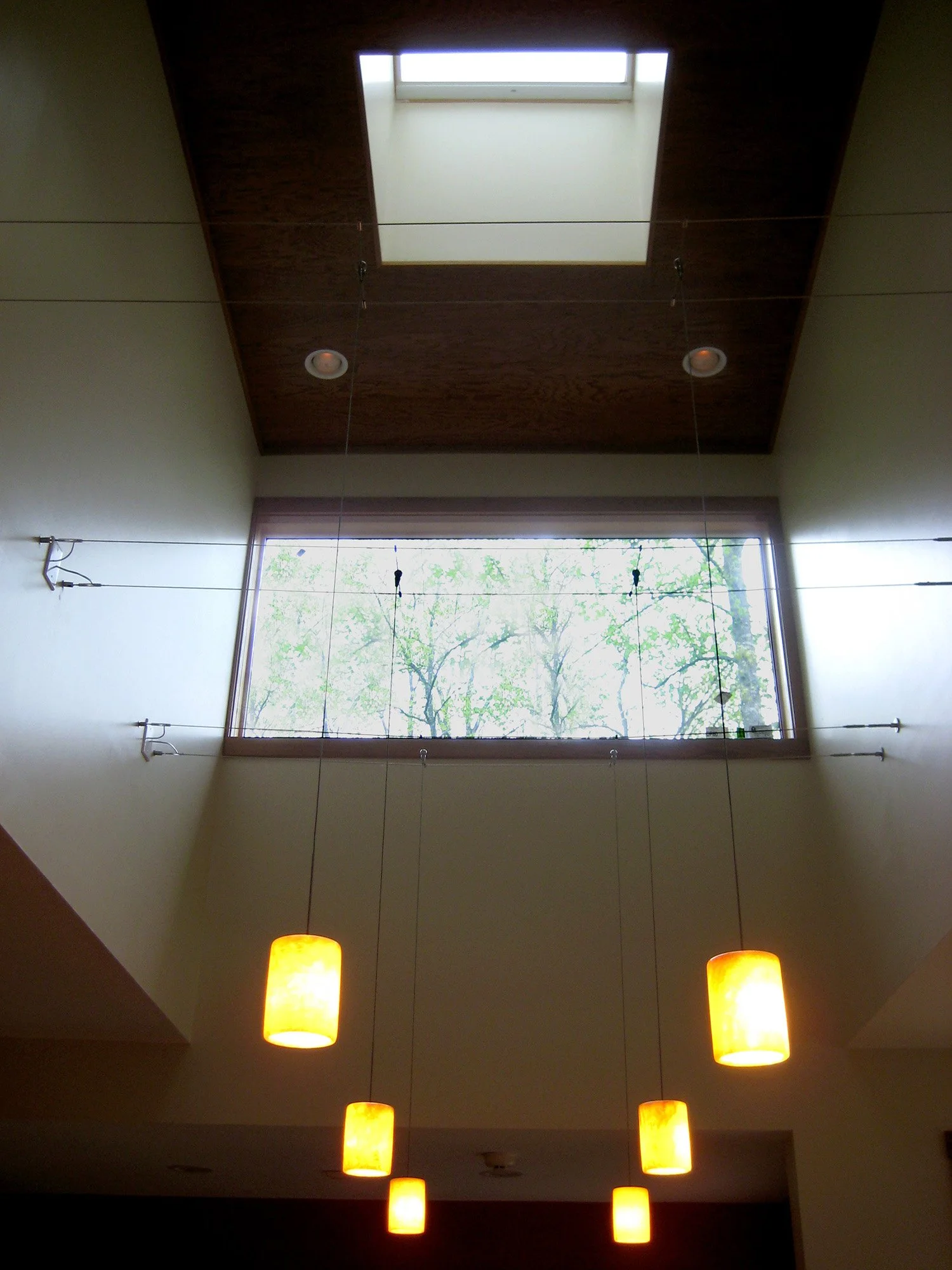 Inspired by the forest canopy, the house uses light, sight, and structure to create a network of visual connection reaching from the forest to the lake beyond.