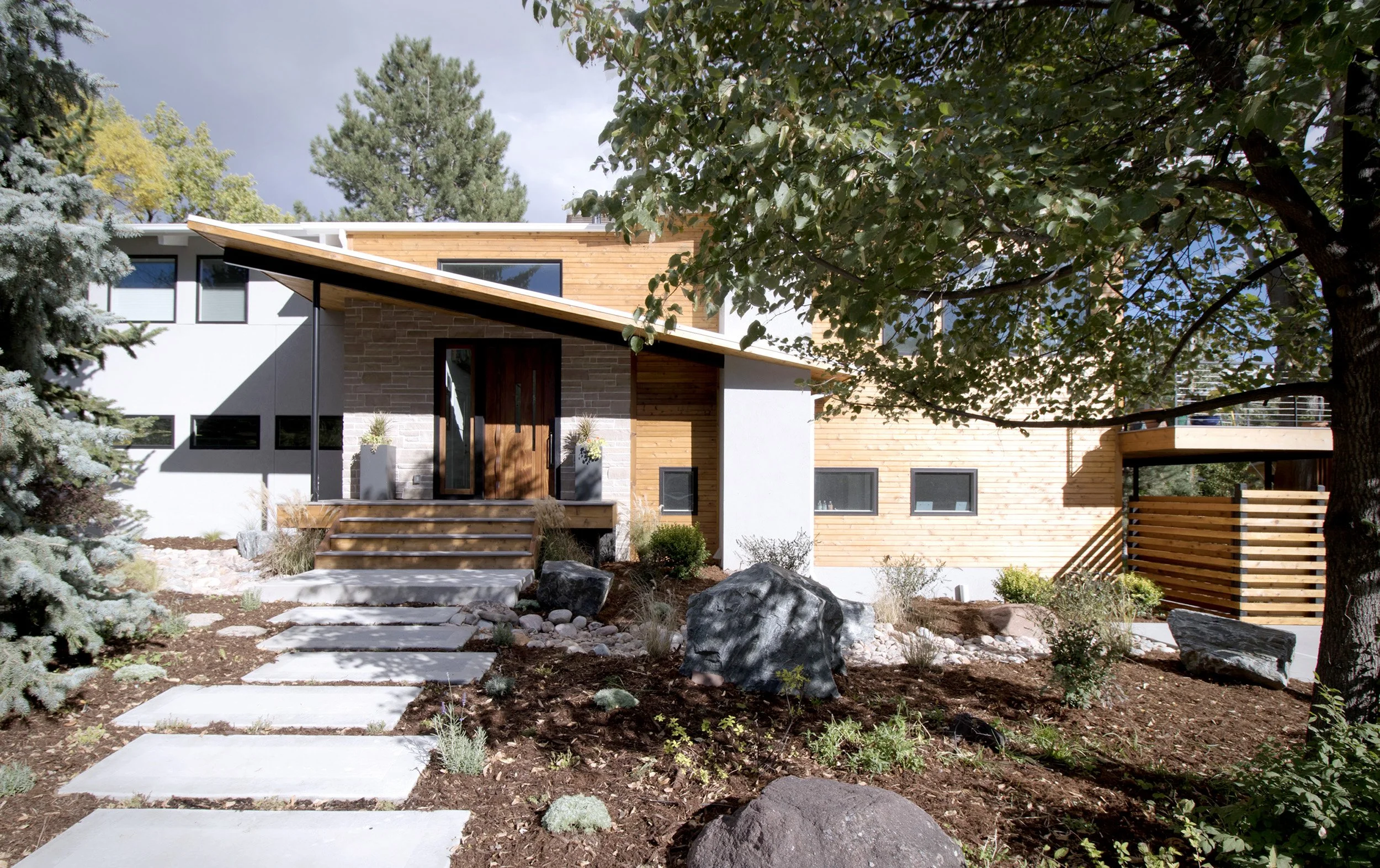 Front elevation of the Phototropic House, a Boulder custom home designed by AsOne Architecture where roof forms, windows, and outdoor spaces are organized around the movement of sunlight.