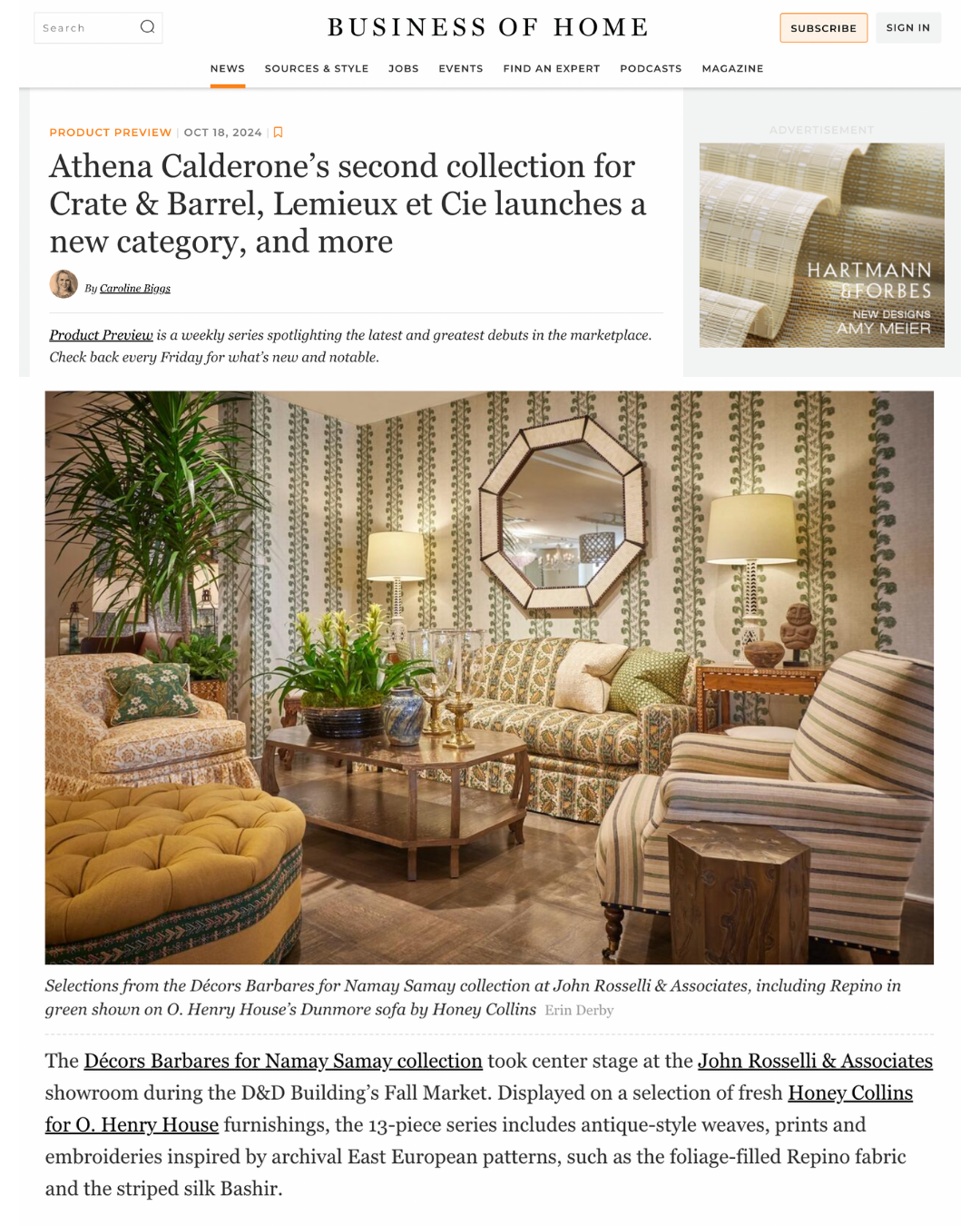 A cozy living room with patterned wallpaper, a mirror on the wall, two table lamps, a floral upholstered sofa, a striped armchair, a carved wooden side table, a wooden coffee table with plants, and a large leafy green plant in the corner.