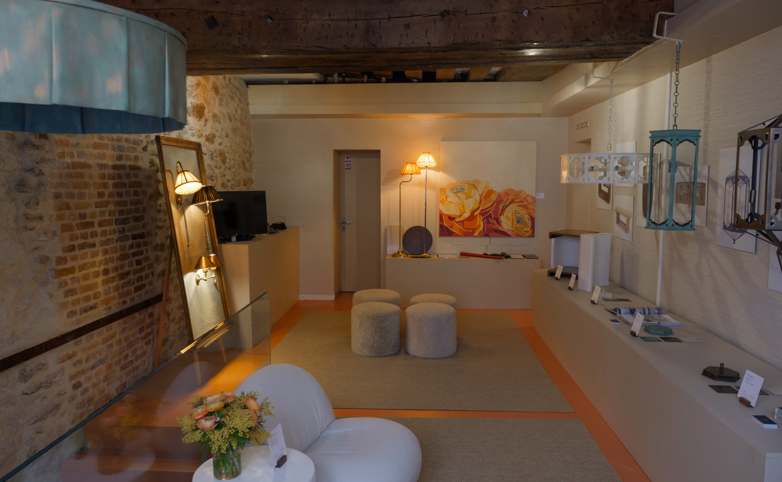 Interior view of a room displaying various decorative items, artwork, furniture, lighting, and a television.