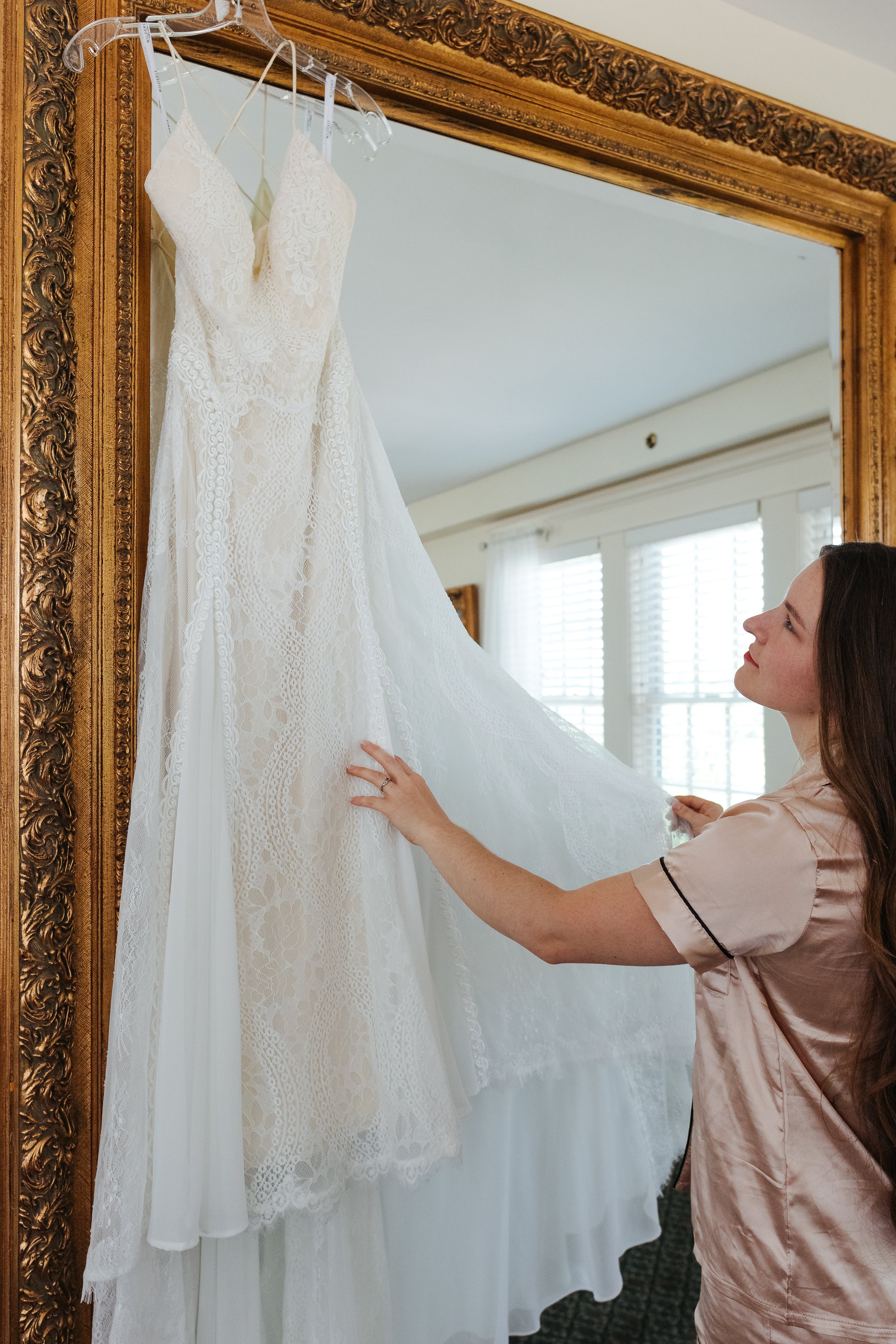 Bride looking at Wedding Dress