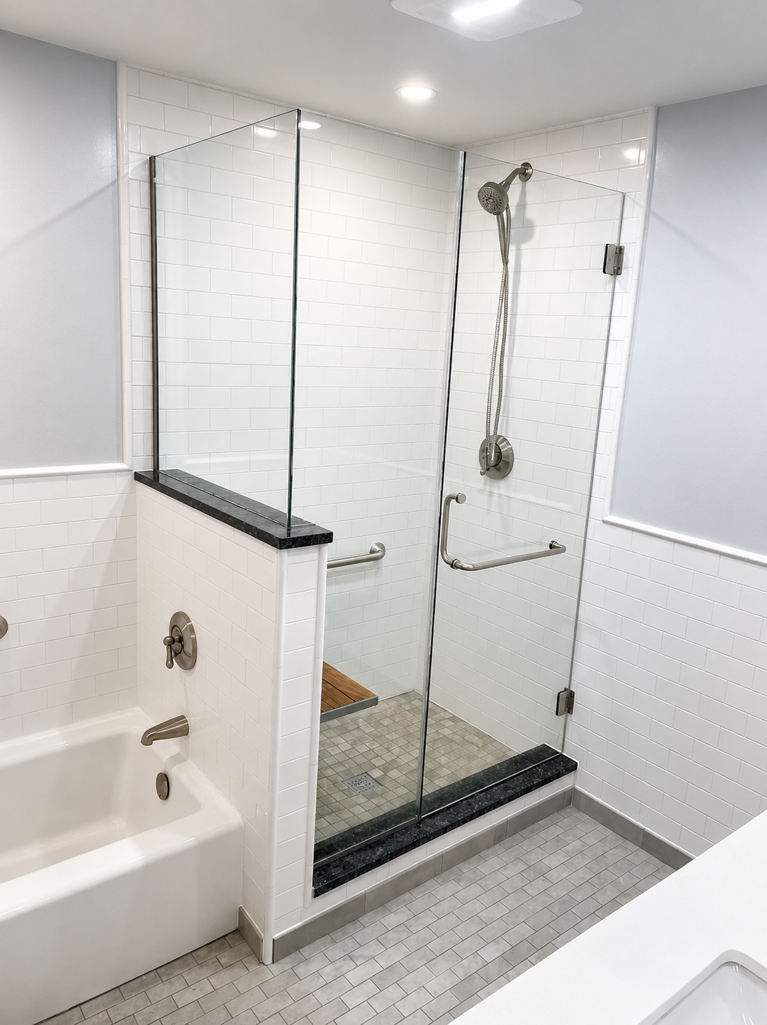 custom shower glass enclosure, granite wall cap and threshold, exterior handle on the door is also a towel bar