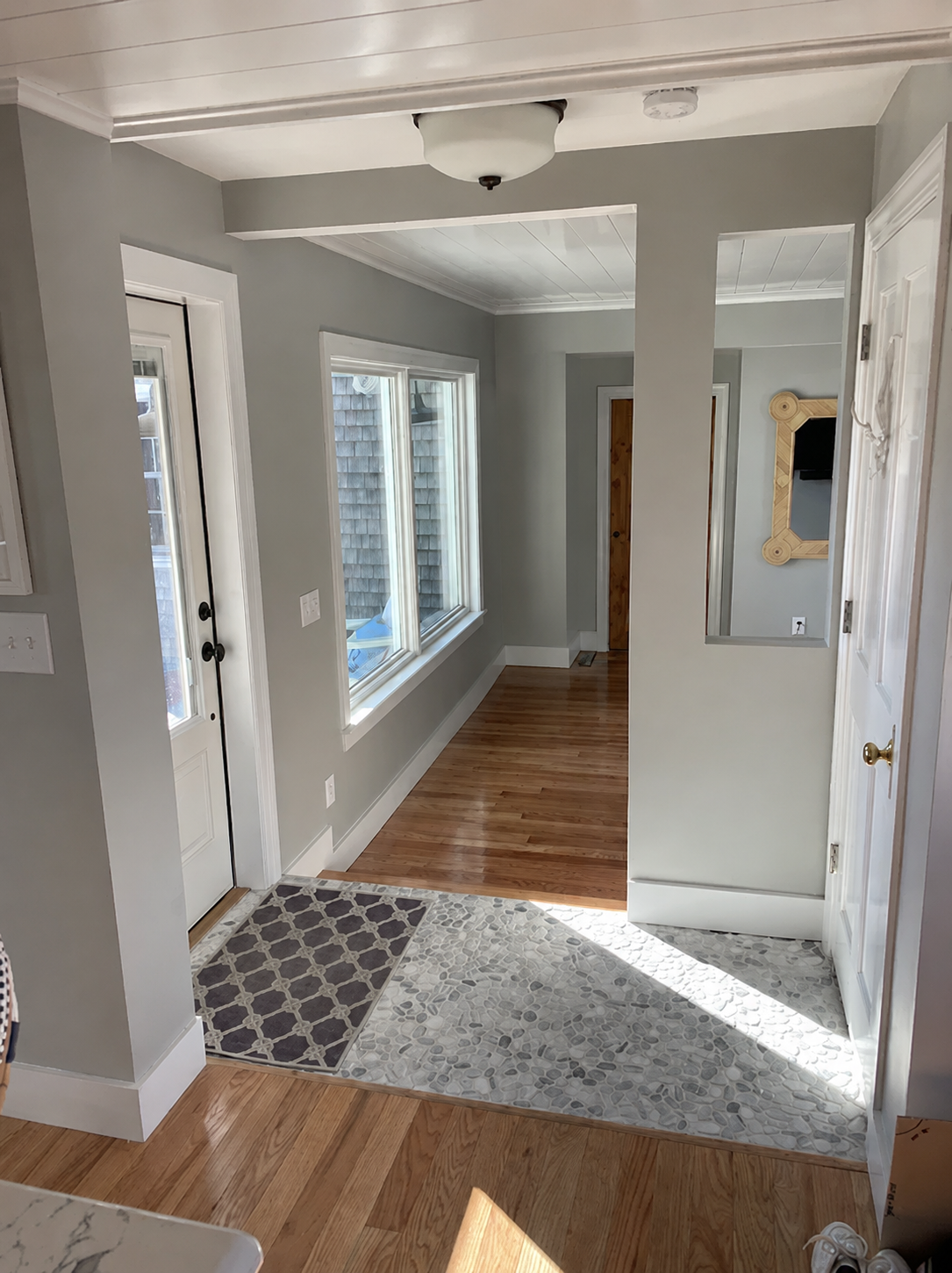 After...With a new entrance door, large picture window and the open wall space, there is a nice sense of flow from one area to another. You would never know that there was a garage there!