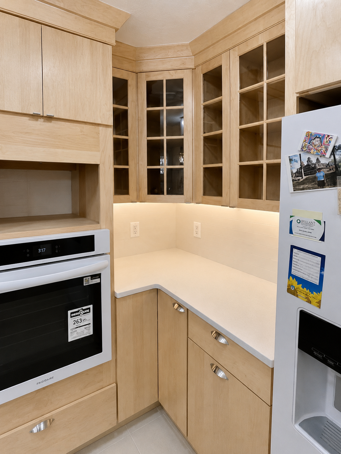 under cabinet lighting, quartz counter top, glass inserts in upper cabinet doors