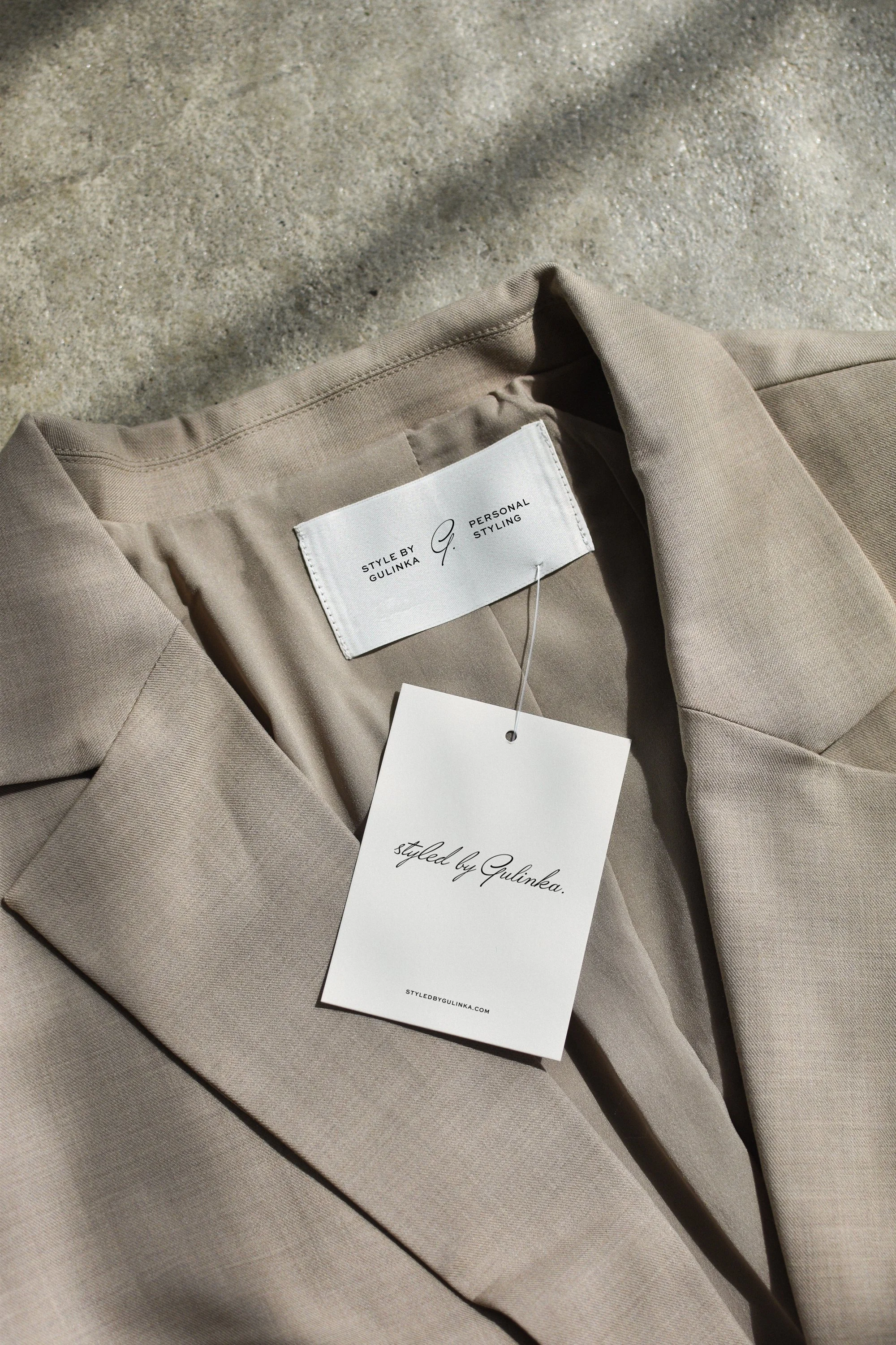 Beige blazer with tags labeled “Styled by Gulinka” – personalised wardrobe styling and brand identity.