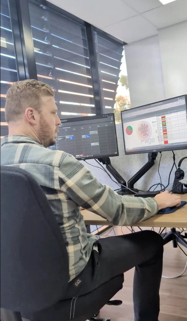 Antony King reviewing asset data dashboards at his desk