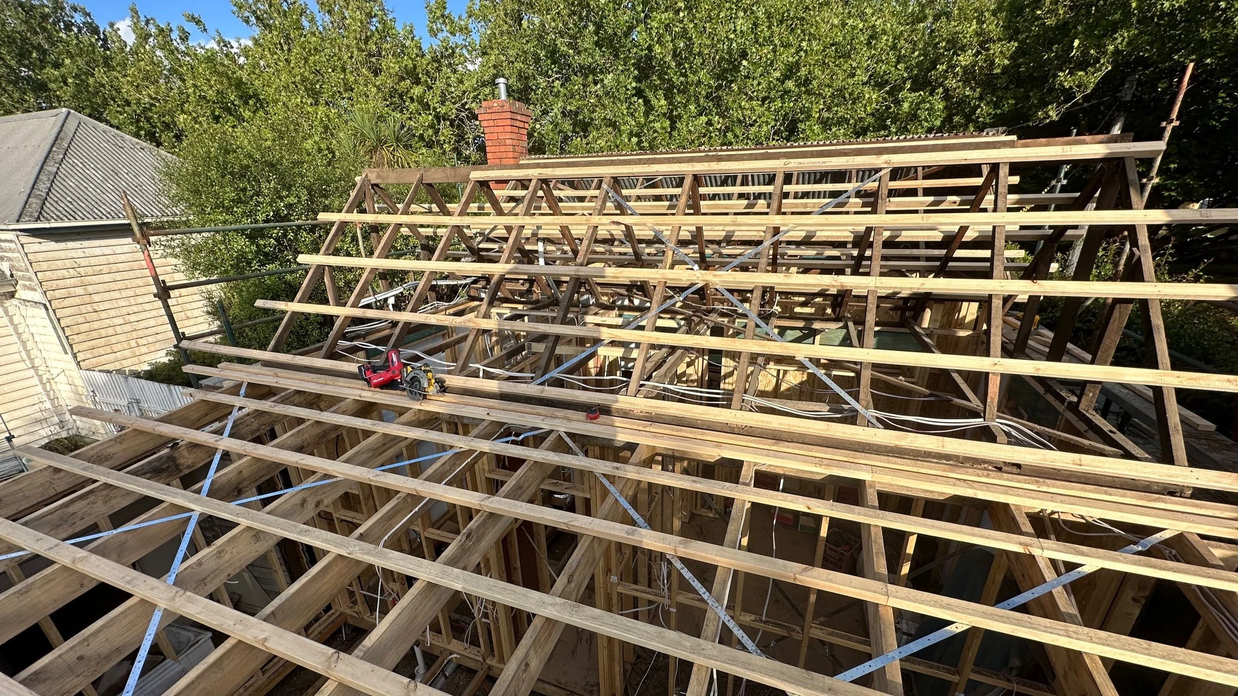 Construction site with timber roof framing and bracing.