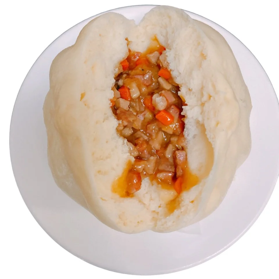 Chinese steamed bun with meat and vegetable filling.
