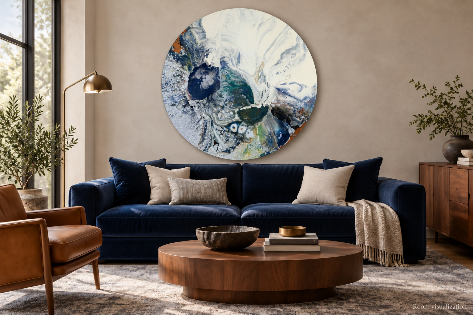 Room visualization of Cheryl Wheeler’s 44-inch round painting Storm Beneath the Surface, with white at the top, above a navy sofa.