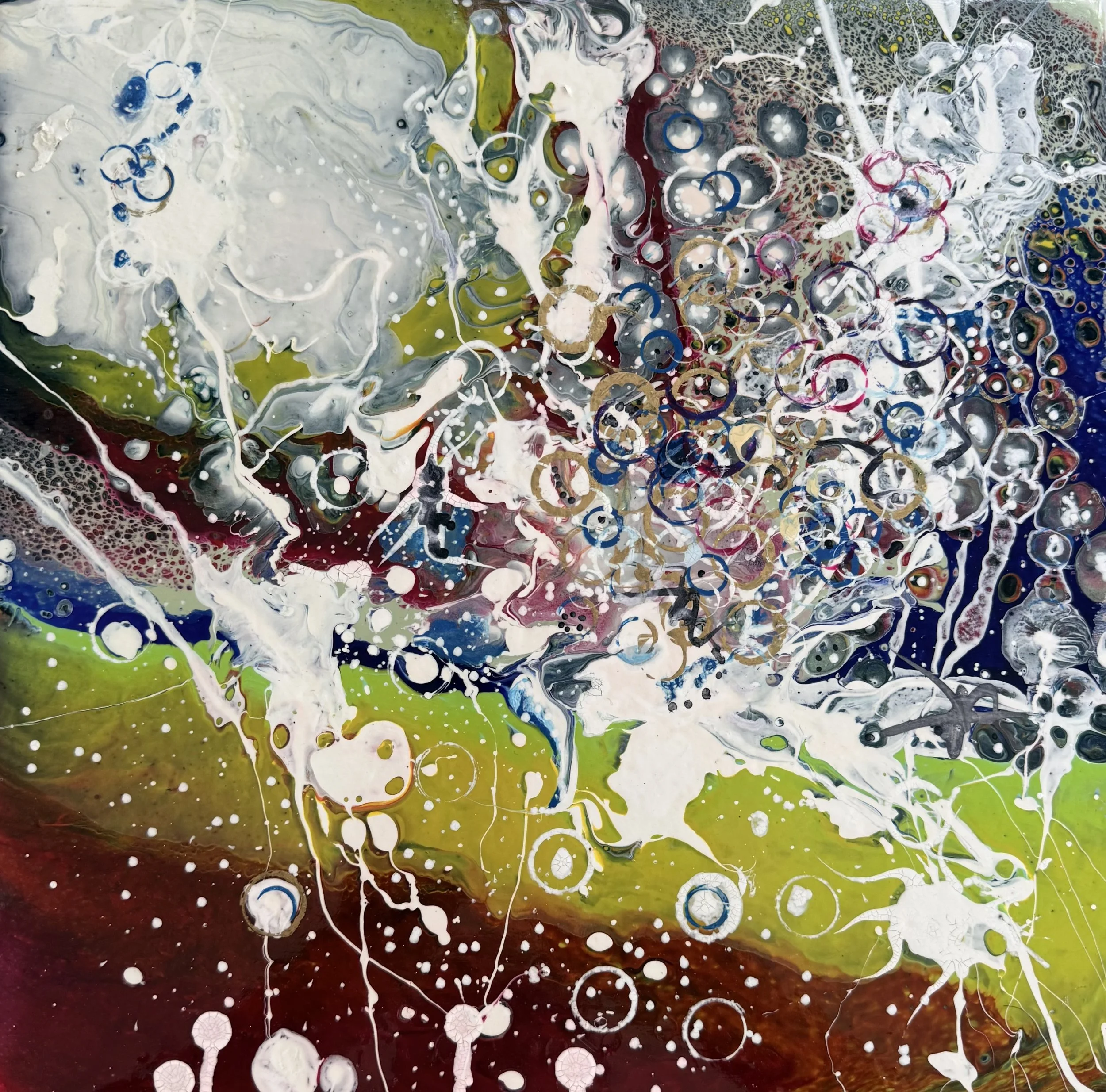 Abstract fluid painting with white, black, blue, green, red, and yellow colors, featuring bubbles and swirling patterns.