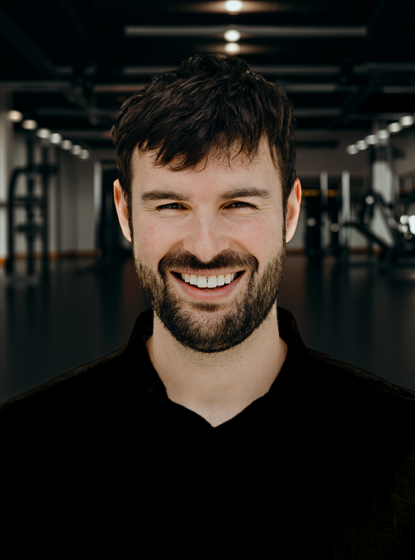 Ben - EBS Head Coach: Smiling man with dark hair and beard in a gym