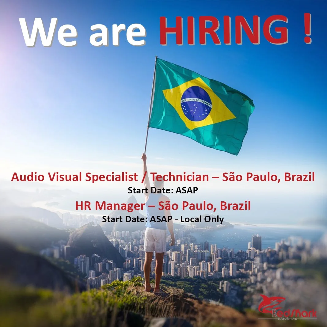 A person holding a Brazilian flag on a mountain overlooking a city in Brazil. Text overlay reads 'We are HIRING!', 'Audio Visual Specialist / Technician - São Paulo, Brazil', 'Start Date: ASAP', 'HR Manager - São Paulo, Brazil', 'Start Date: ASAP - Local Only'.