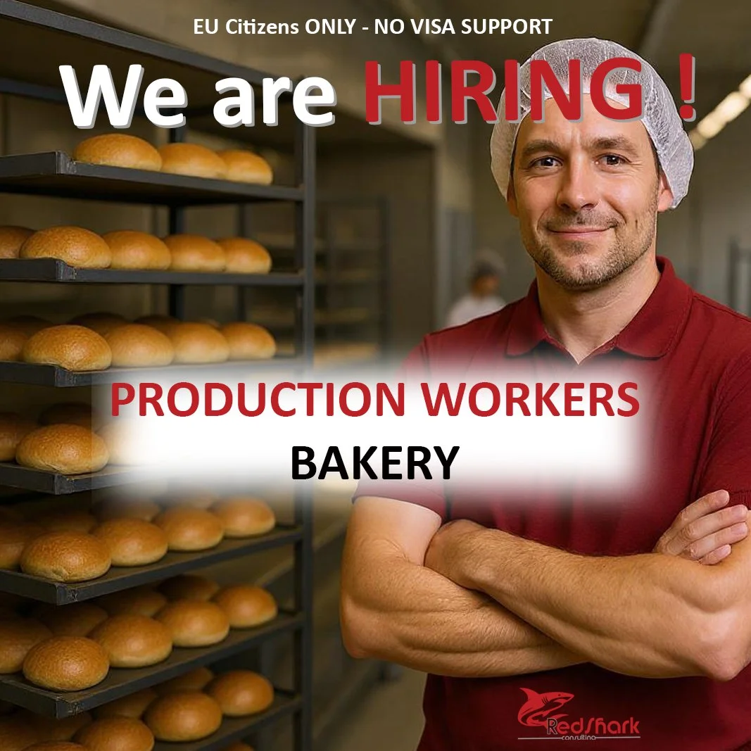 Bakery production worker standing in a bakery next to racks of bread, wearing a hairnet and red shirt, with overlaid text that says 'We are HIRING! Production Workers Bakery'; small RedShark logo at the bottom.