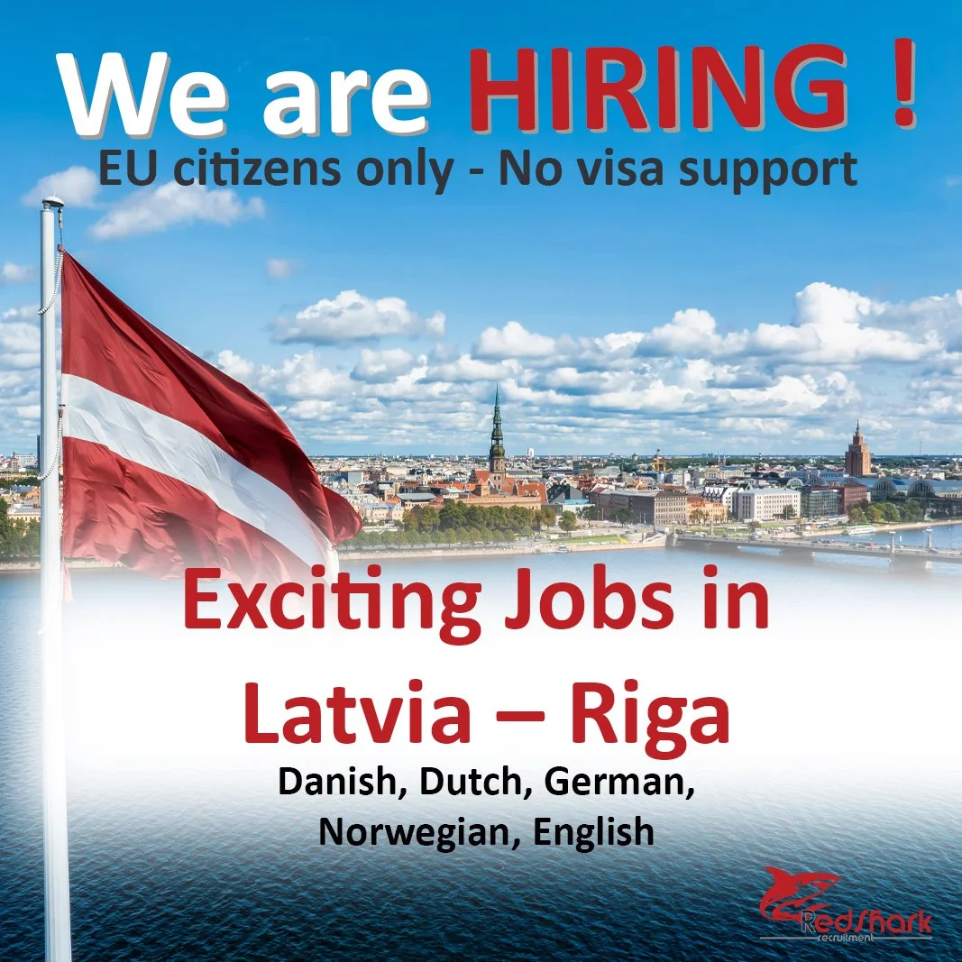 An advertisement with a view of Riga, Latvia, featuring a Latvian flag against a cityscape with a river, historic buildings, and a blue sky with clouds. The text announces job openings for EU citizens in Riga, Latvia, with language requirements including Danish, Dutch, German, Norwegian, and English.