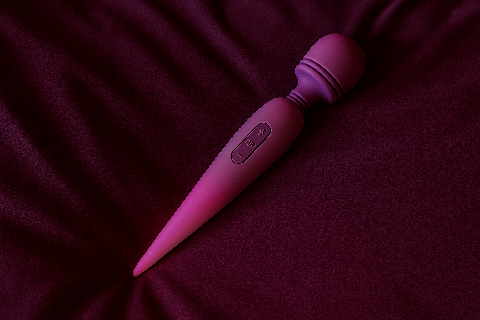 A purple handheld personal massager with control buttons on a dark purple satin fabric background.