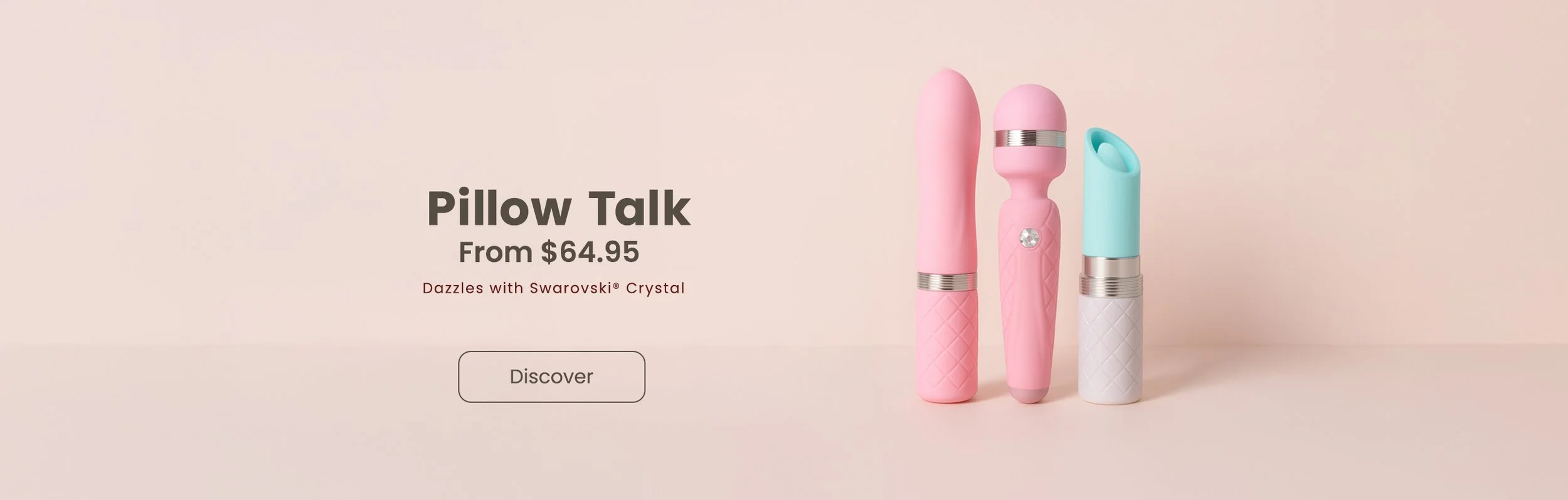 Soft pink and blue devices shaped like pillows on a light beige background, with the text "Pillow Talk From $64.95 Dazzles with Swarovski Crystal" and a discover button underneath.