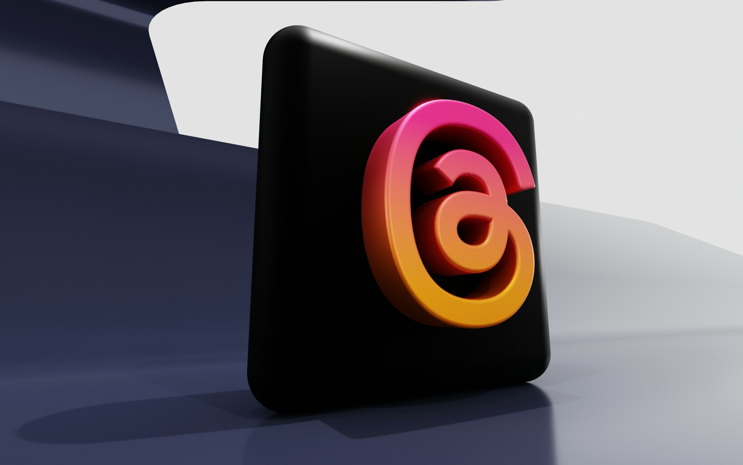 A black rectangular object with a colorful, glowing logo on it, placed on a flat surface with a smooth gradient background.