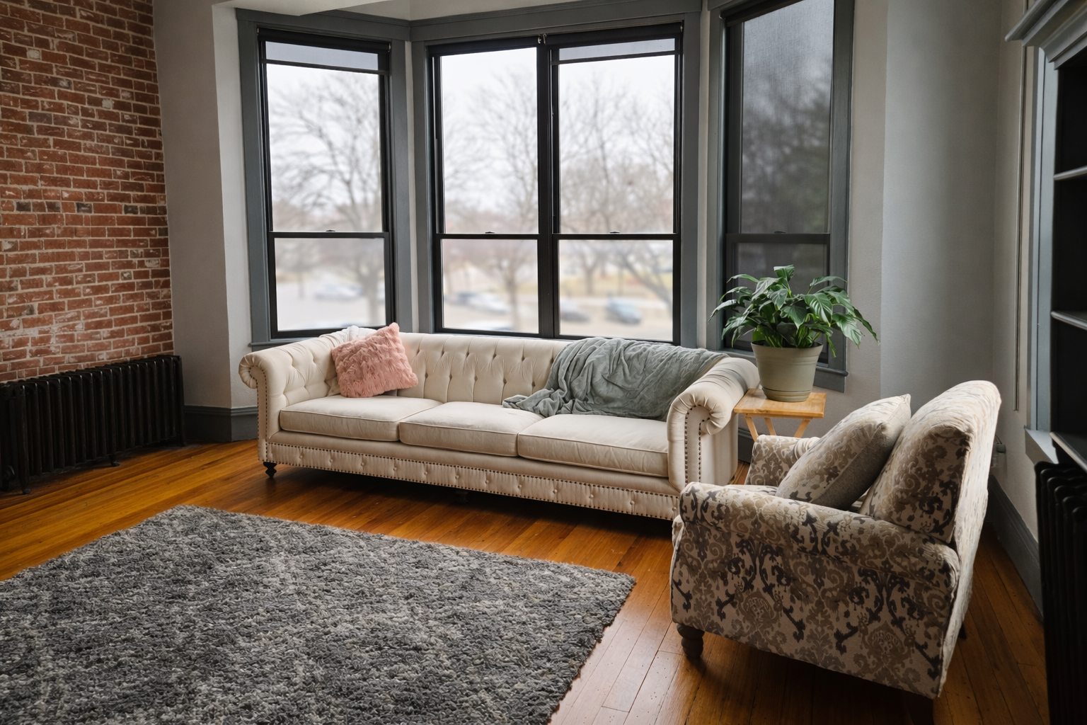 cozy therapy room with white couch, patterned armchair and gray cozy rug