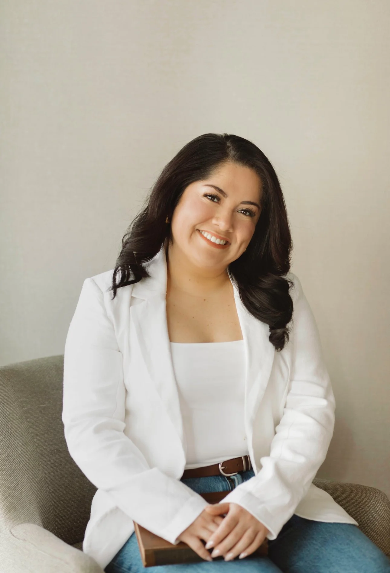 latina therapist in white jacket smiling