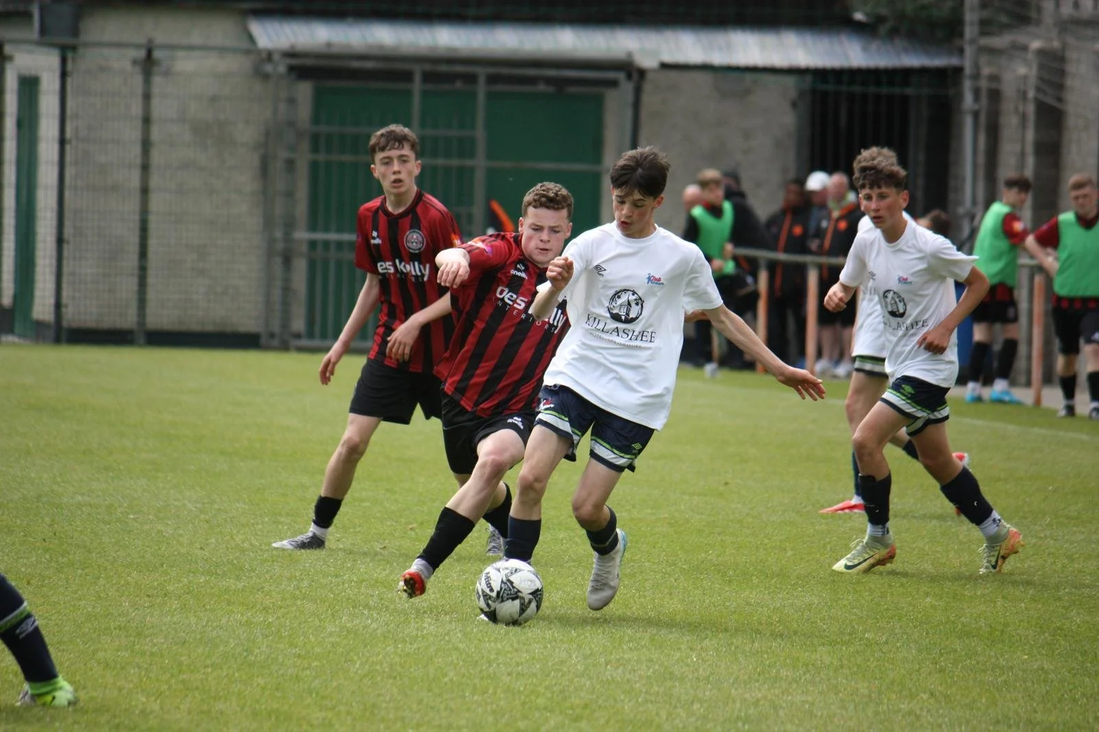Boys playing soccer, tackle being attempted