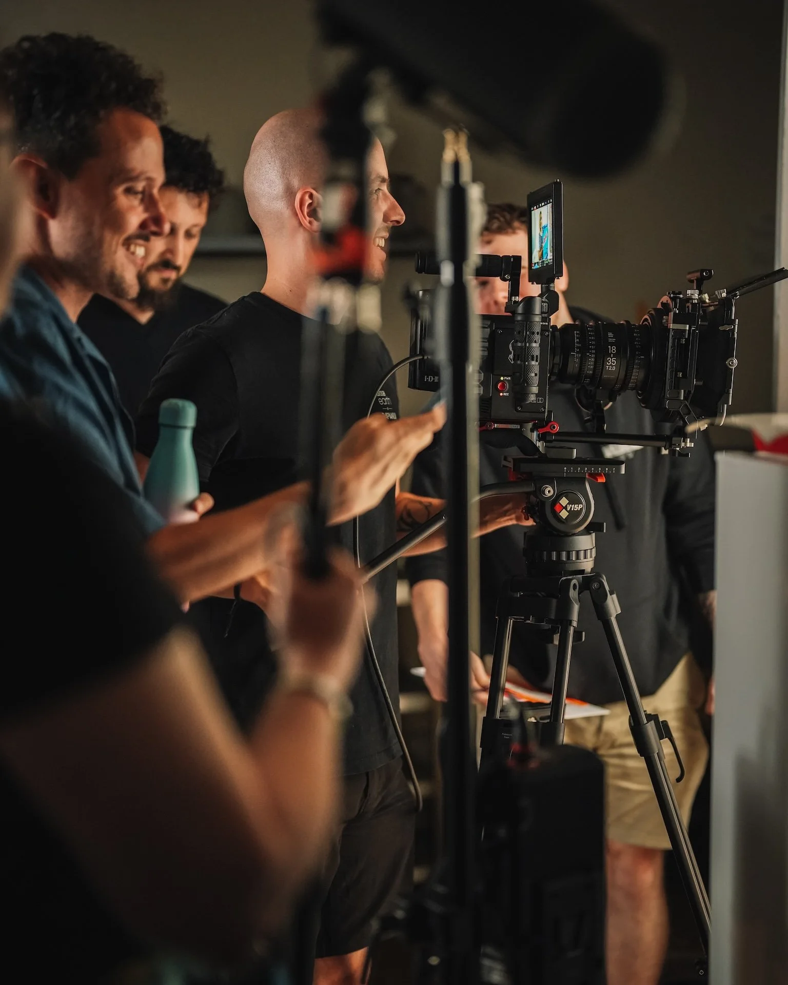 Group of people working on a film set with professional camera equipment.