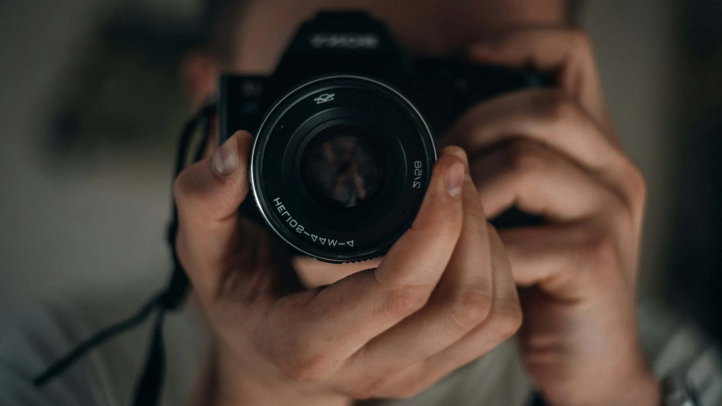 Person taking a photo with a camera, viewed from above.