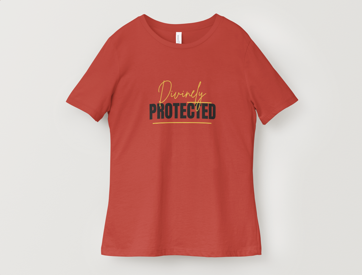 Red T-shirt with the words "Divinely Protected" printed on the front, with "Divinely" in yellow cursive and "Protected" in bold black uppercase letters.