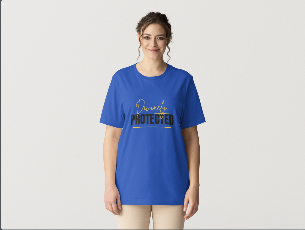 A woman wearing a blue T-shirt with the words "Divinely Protected" printed on it, standing against a plain white background.