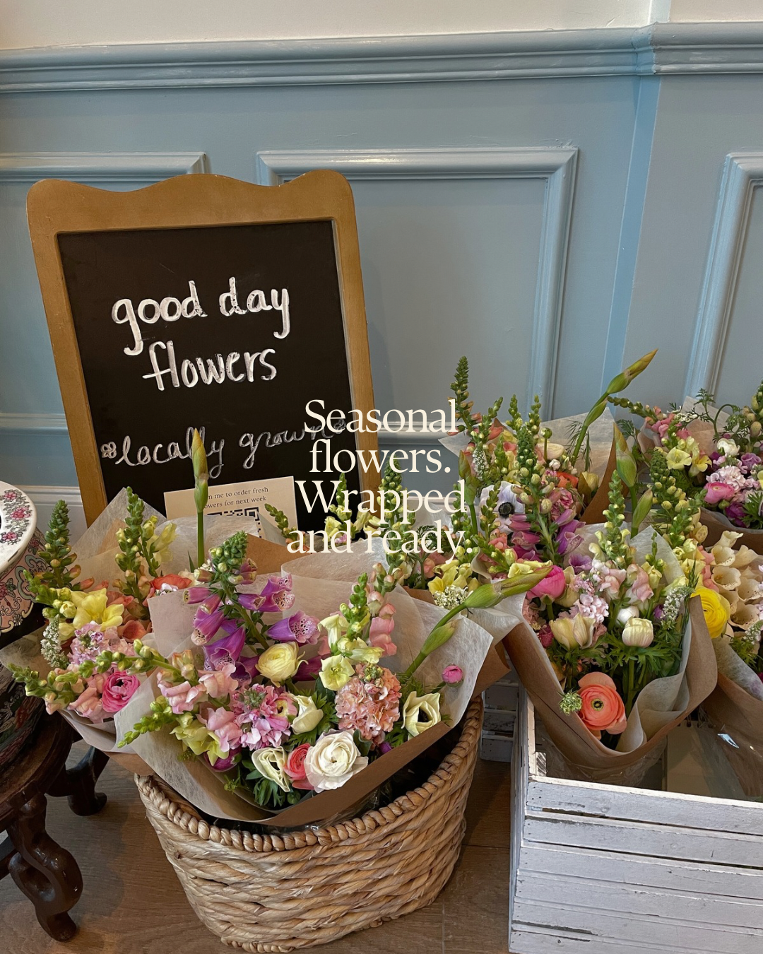 Imagine features bouquets in a wooden crate next to a “good day flowers” sign with text overlay stating “