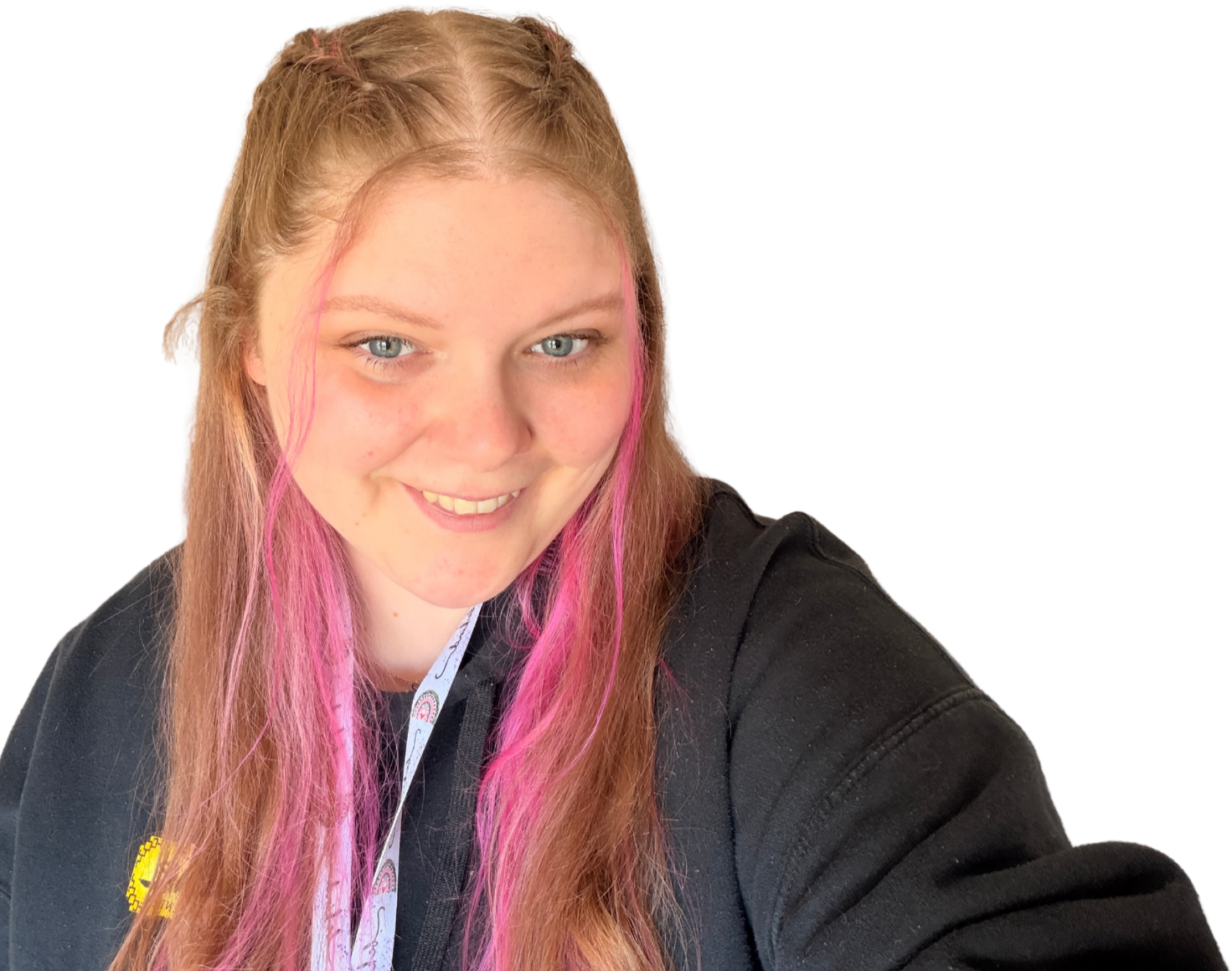 Portrait of Kara Hunter smiling, with long brown hair featuring pink highlights, wearing a black jumper against a transparent background.