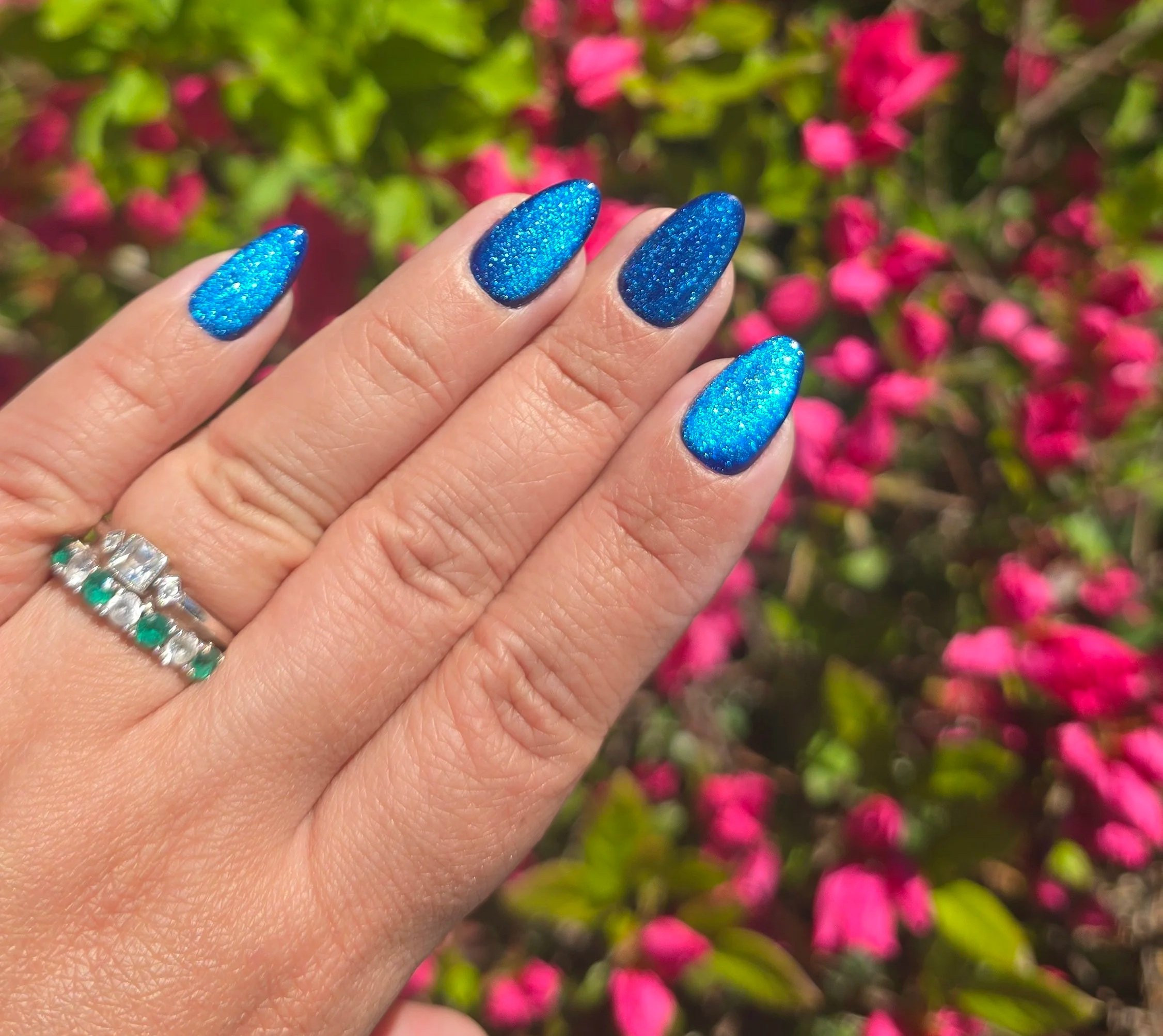 Handmade blue cat-eye luxury press-on nails in a short almond shape with a glossy finish.
