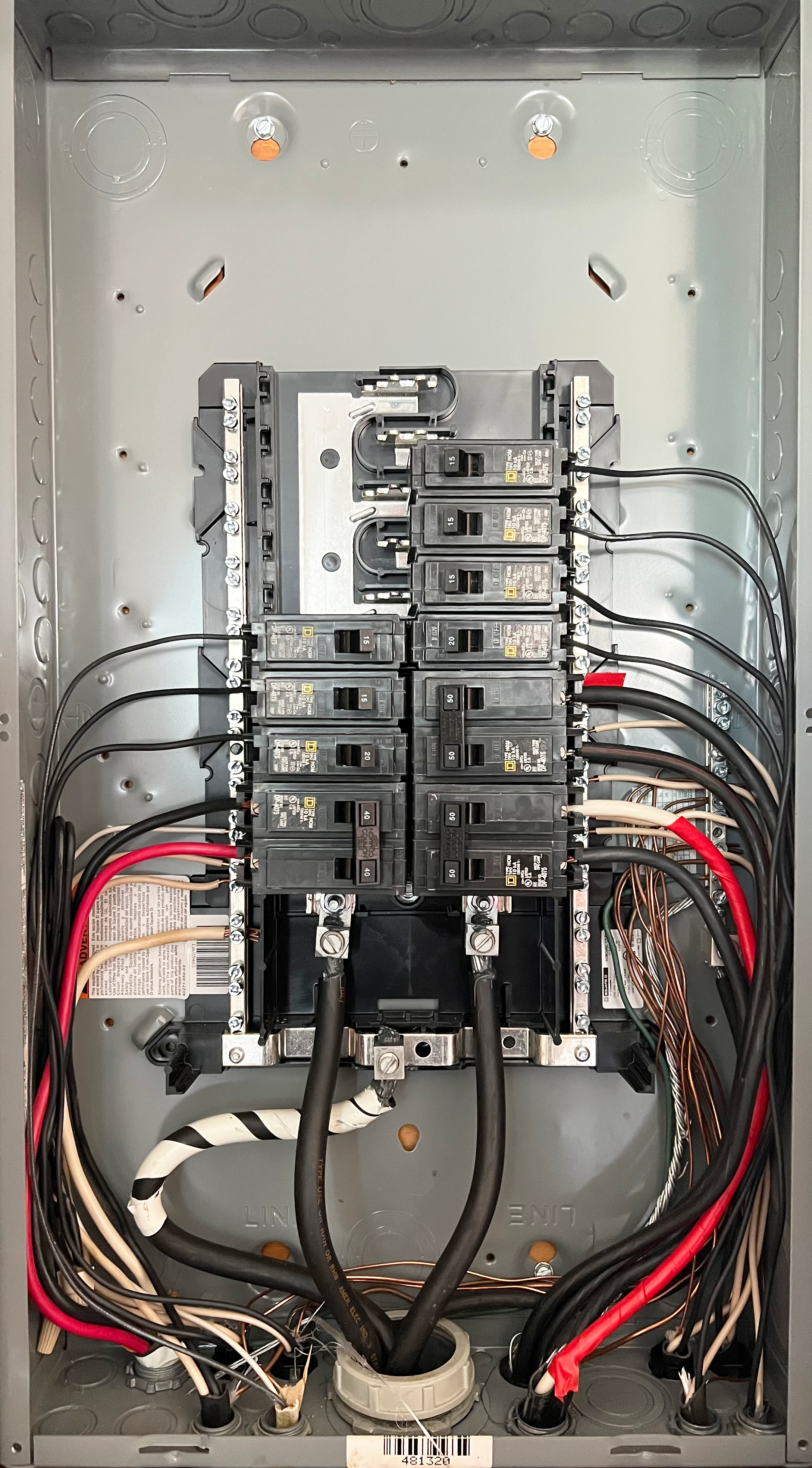 Inside an electrical panel with circuit breakers and wiring.