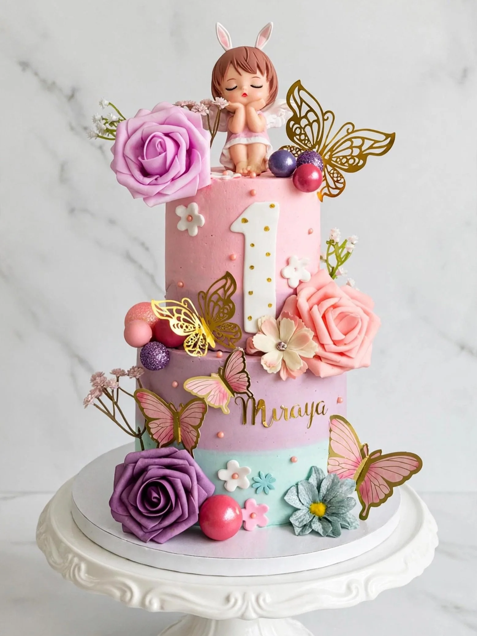 She&rsquo;s ONE-derful, she&rsquo;s magical, she&rsquo;s loved beyond words 💕
From tiny toes to fairy wings &mdash; celebrating 1 year of Miraya.

2-Tier Fairy Garden First Birthday Cake 🌷
Pastel buttercream ombre in pink, lilac &amp; mint, roses, 