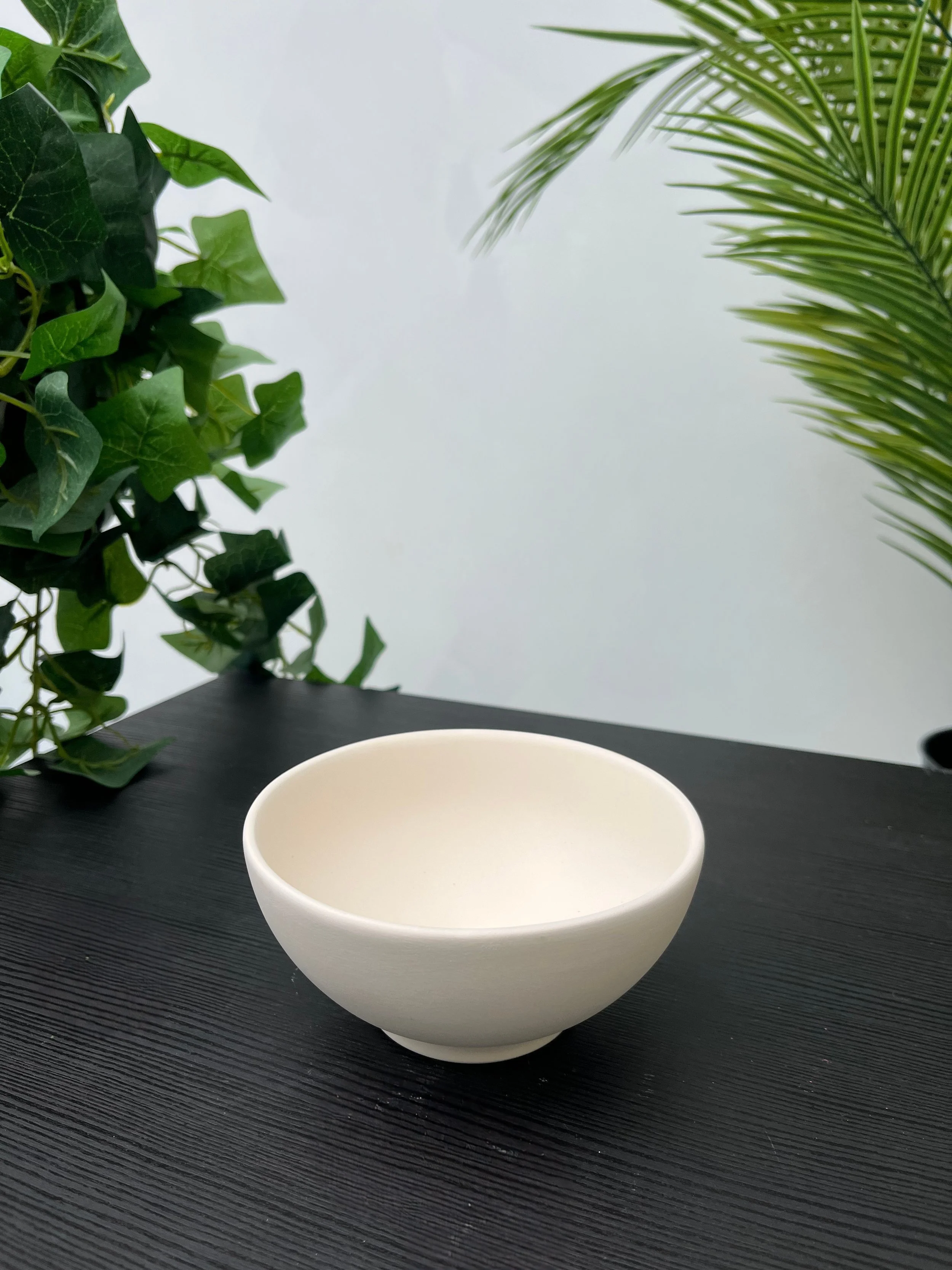 White ceramic bowl on a dark wooden table