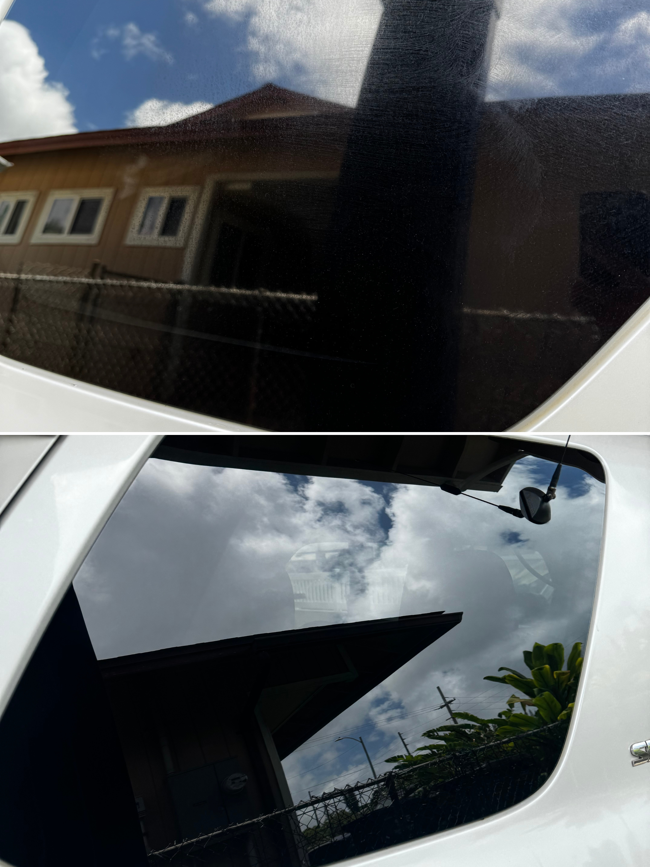 Reflection of a house with a triangular roof and windows, cloudy blue sky, and power lines, seen through the tinted front windshield of a white vehicle.